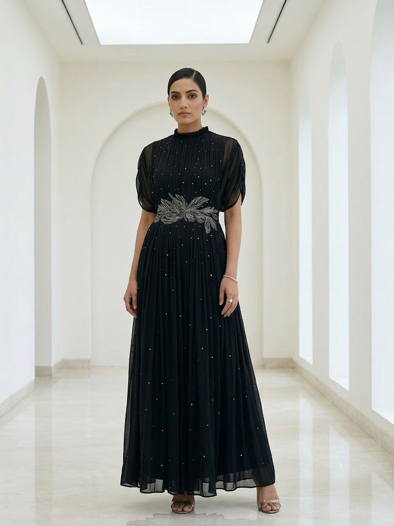 BLACK SEQUIN AND WIRE EMBELLISHED PLEATED GOWN WITH SHEER SLEEVES.