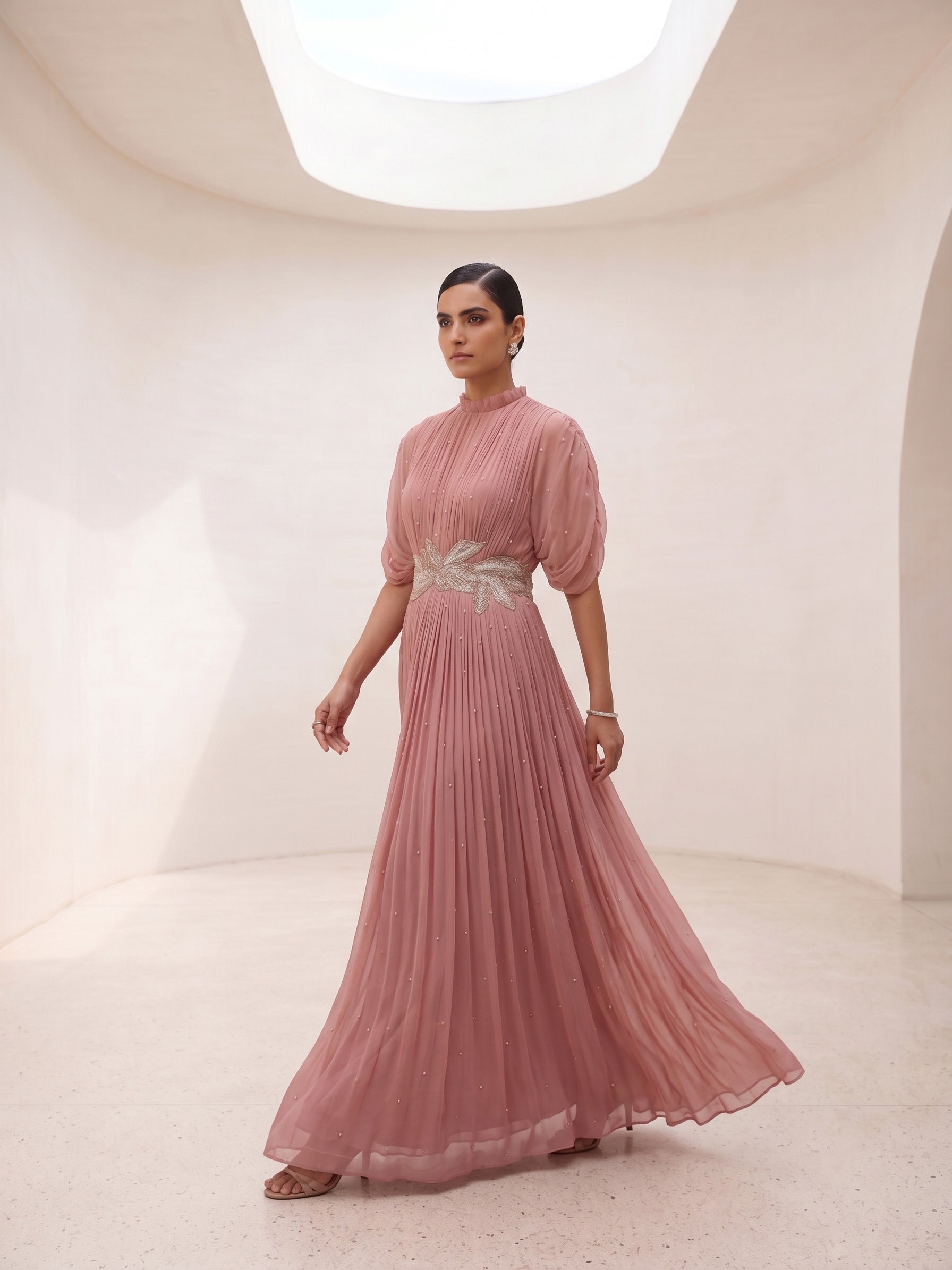DUSTY ROSE SEQUIN AND WIRE EMBELLISHED PLEATED GOWN WITH SHEER SLEEVES.