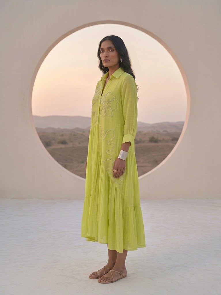 ELEGANT GREEN FLARED DRESS FEATURING DELICATE FLORAL EMBROIDERY.