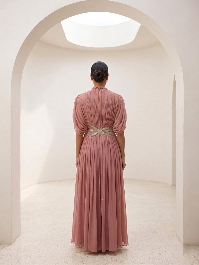 DUSTY ROSE SEQUIN AND WIRE EMBELLISHED PLEATED GOWN WITH SHEER SLEEVES.