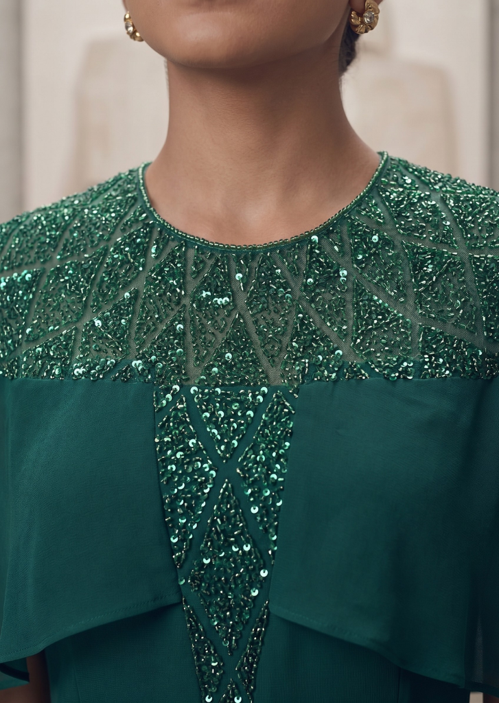 GREEN SEQUIN AND BEAD EMBELLISHED GOWN WITH SHEER NECKLINE.