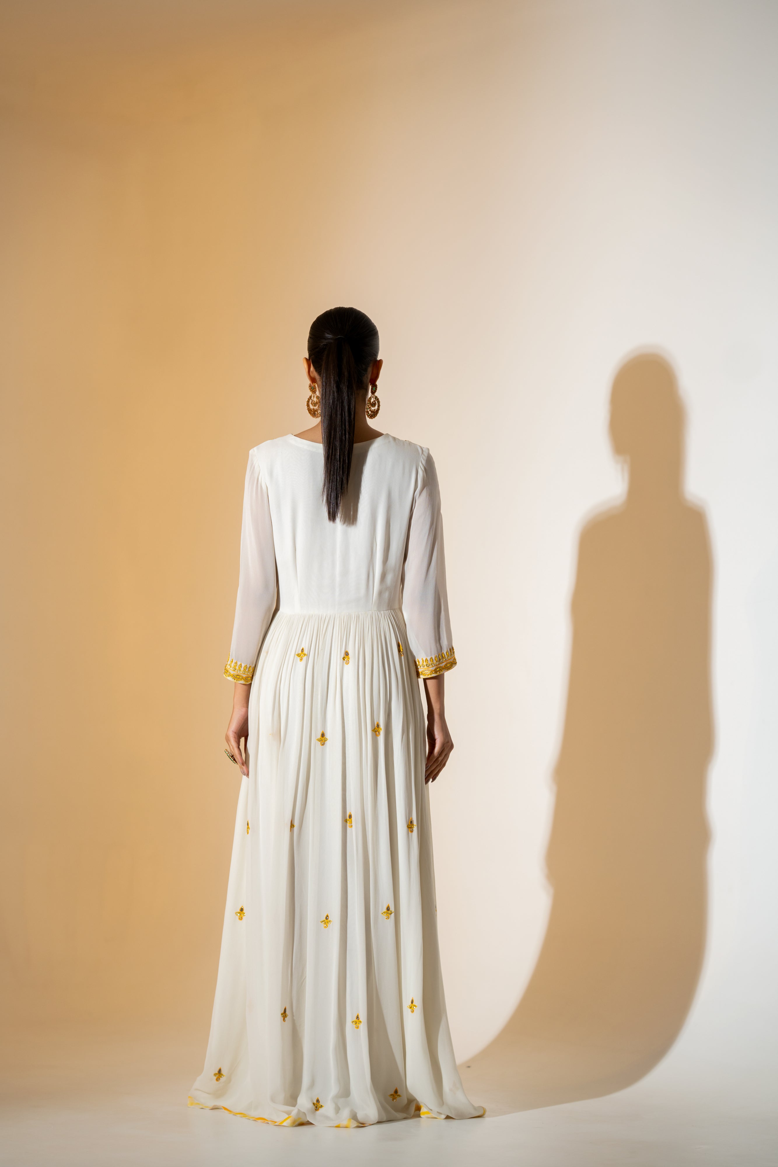 OFF- WHITE  ANARKALI WITH AN EMBROIDERED BODICE AND YELLOW TONE LEHERIYA DUPATTA .
