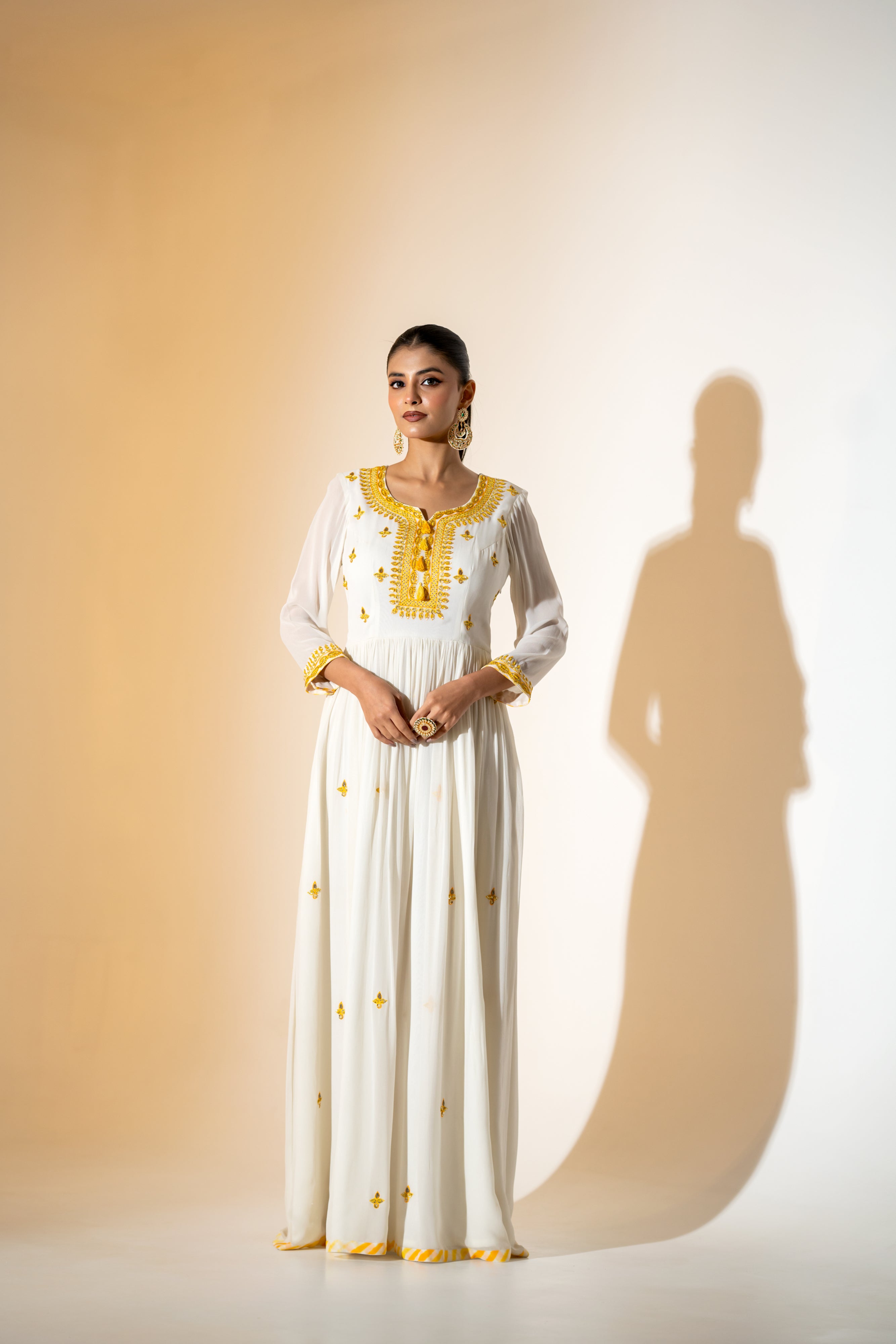 OFF- WHITE  ANARKALI WITH AN EMBROIDERED BODICE AND YELLOW TONE LEHERIYA DUPATTA .