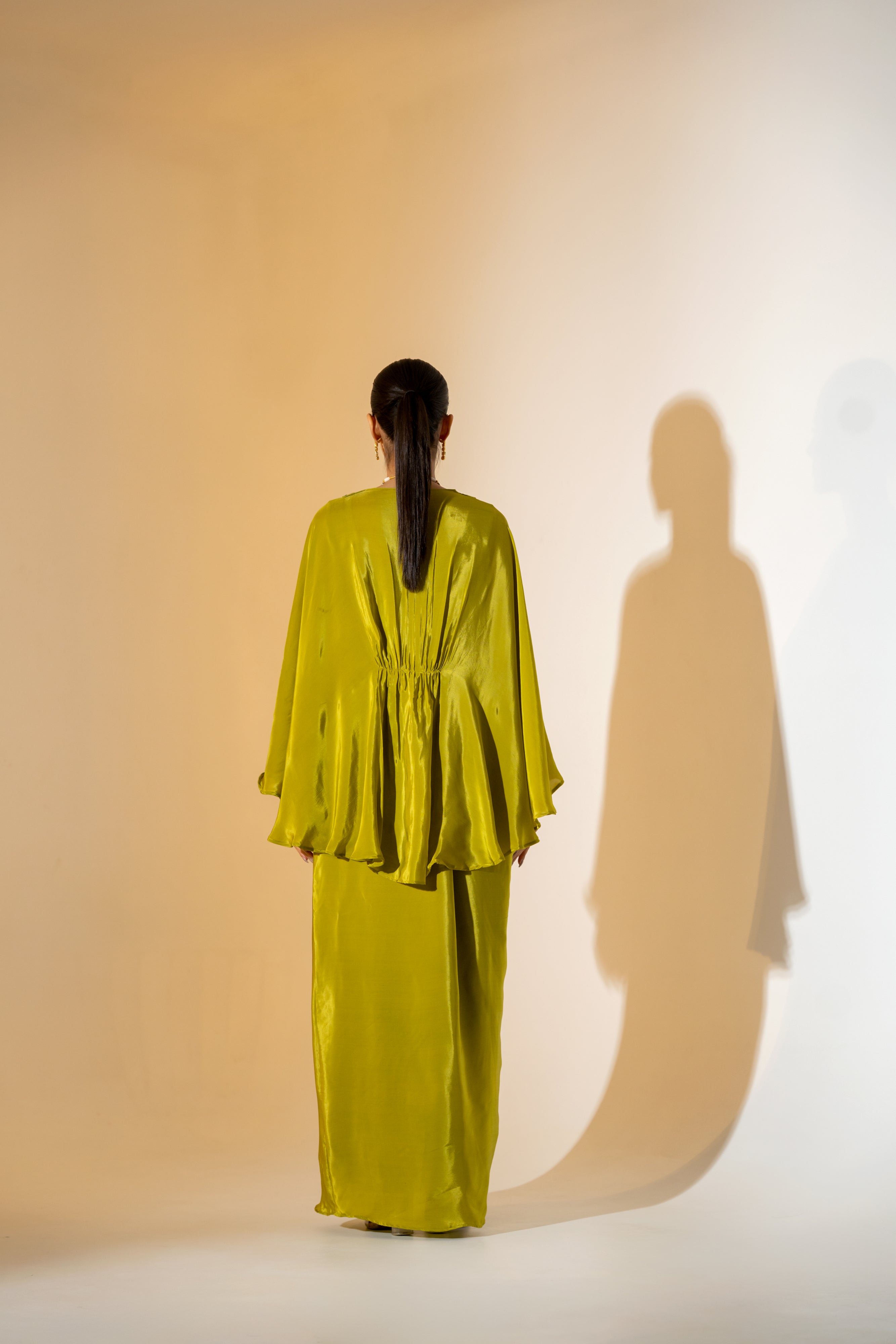 CHARTREUSE DRAPED SKIRT SET WITH CAPE- STYLE TOP AND EMBROIDERED YOKE.