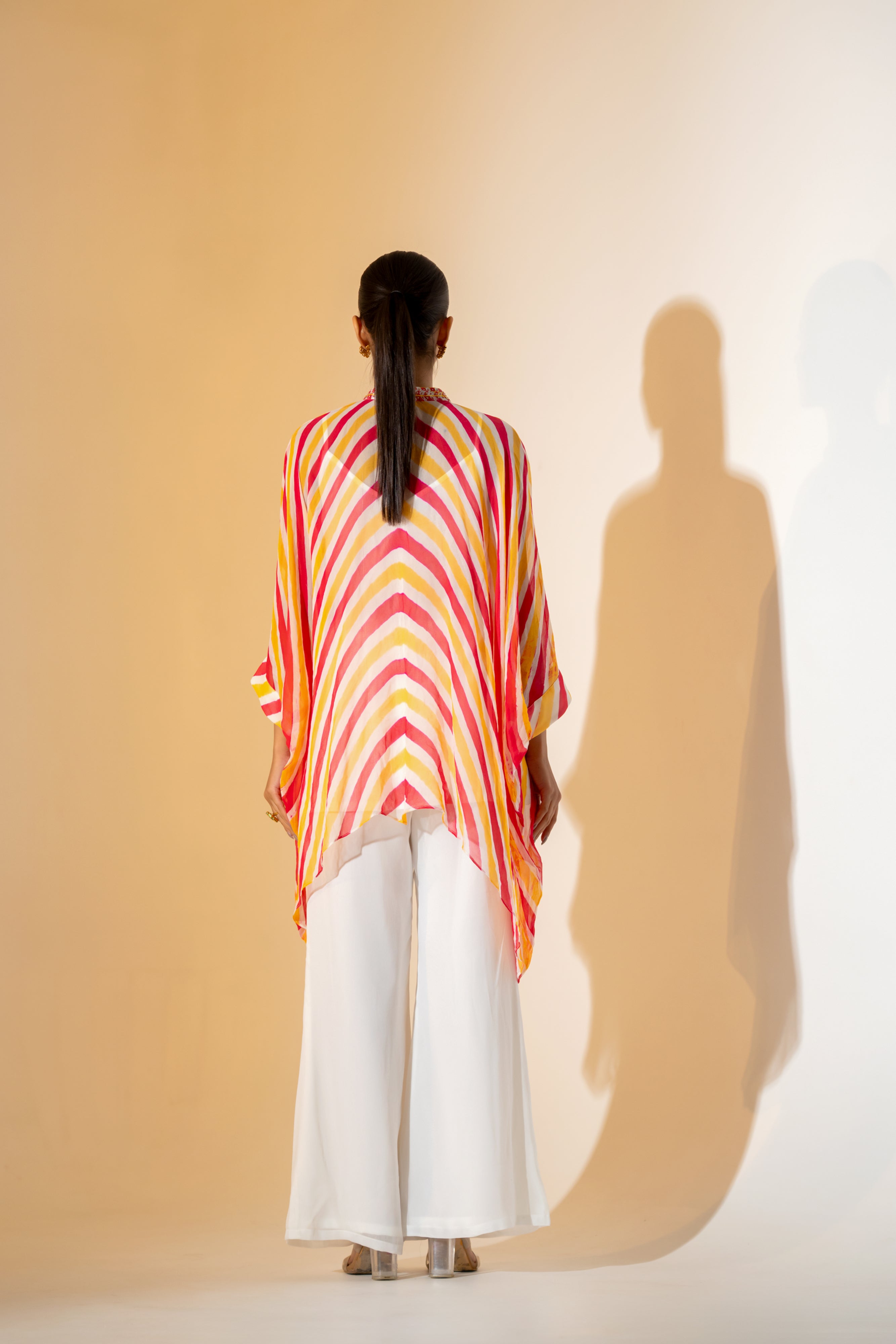 CORALl AND YELLOW LEHERIYA KAFTAN TOP WITH  EMBROIDERED NECKLINE & WHITE PANT.