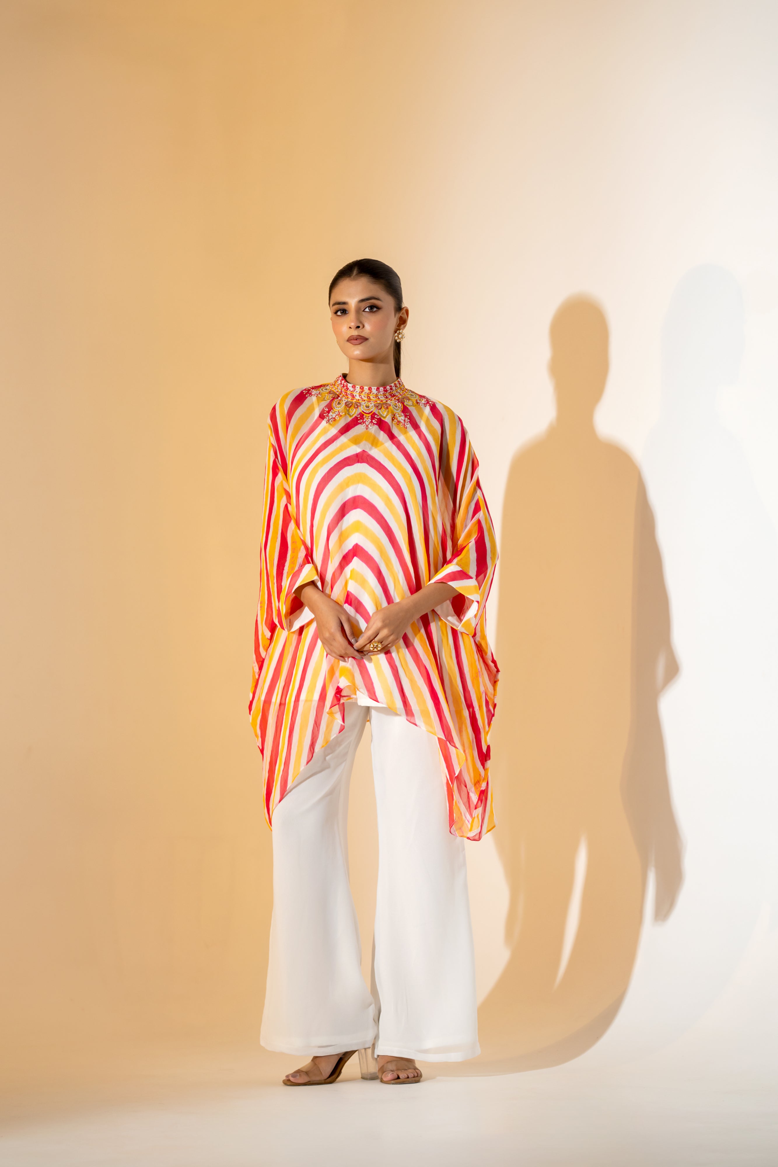CORALl AND YELLOW LEHERIYA KAFTAN TOP WITH  EMBROIDERED NECKLINE & WHITE PANT.