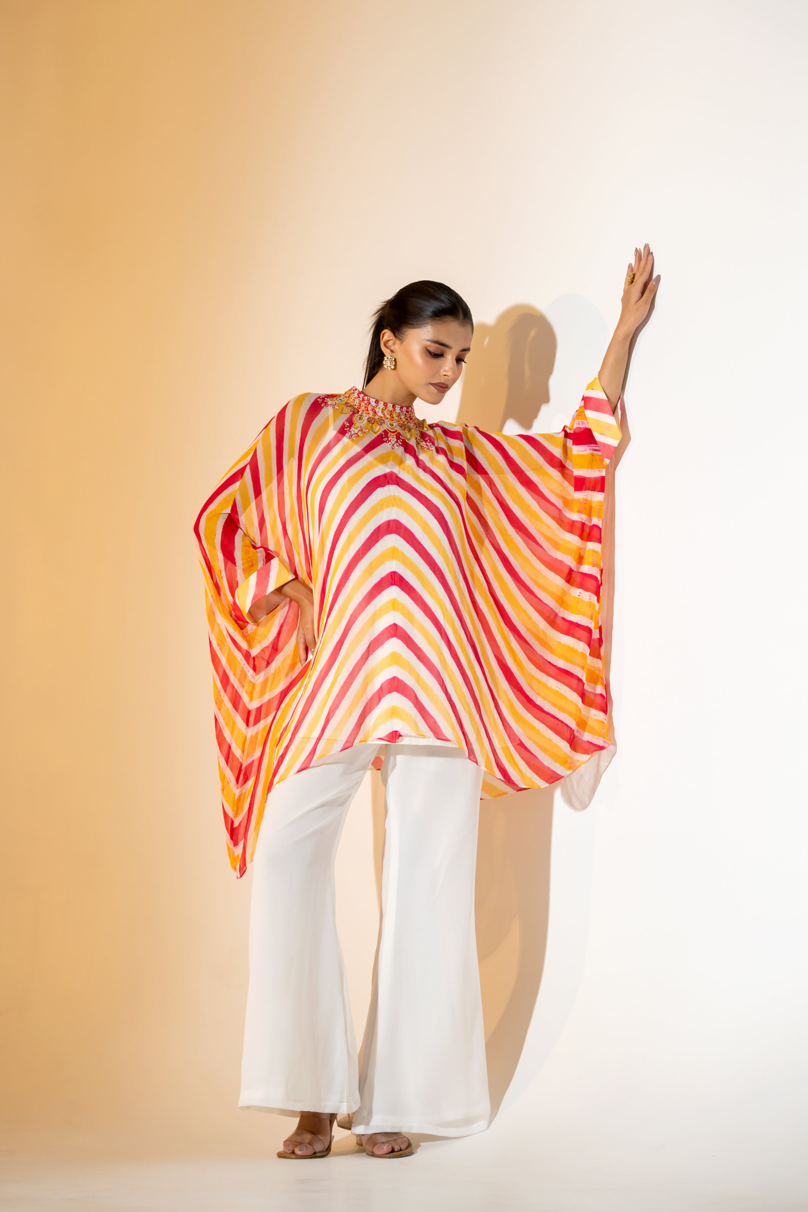 CORALl AND YELLOW LEHERIYA KAFTAN TOP WITH  EMBROIDERED NECKLINE & WHITE PANT.