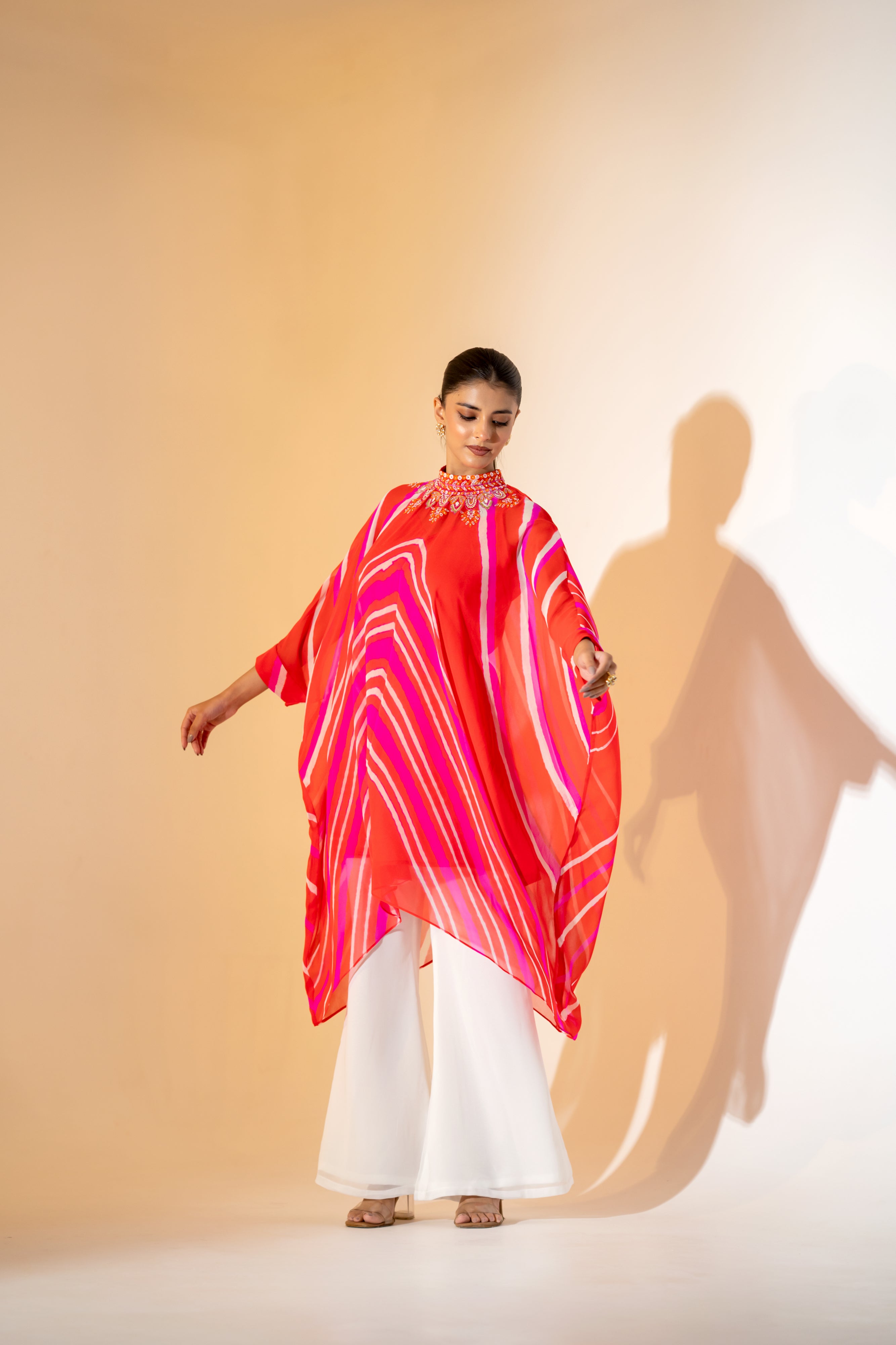 ORANGE AND PINK LEHERIYA KAFTAN TOP WITH EMBROIDERED NECKLINE & WHITE PANT.