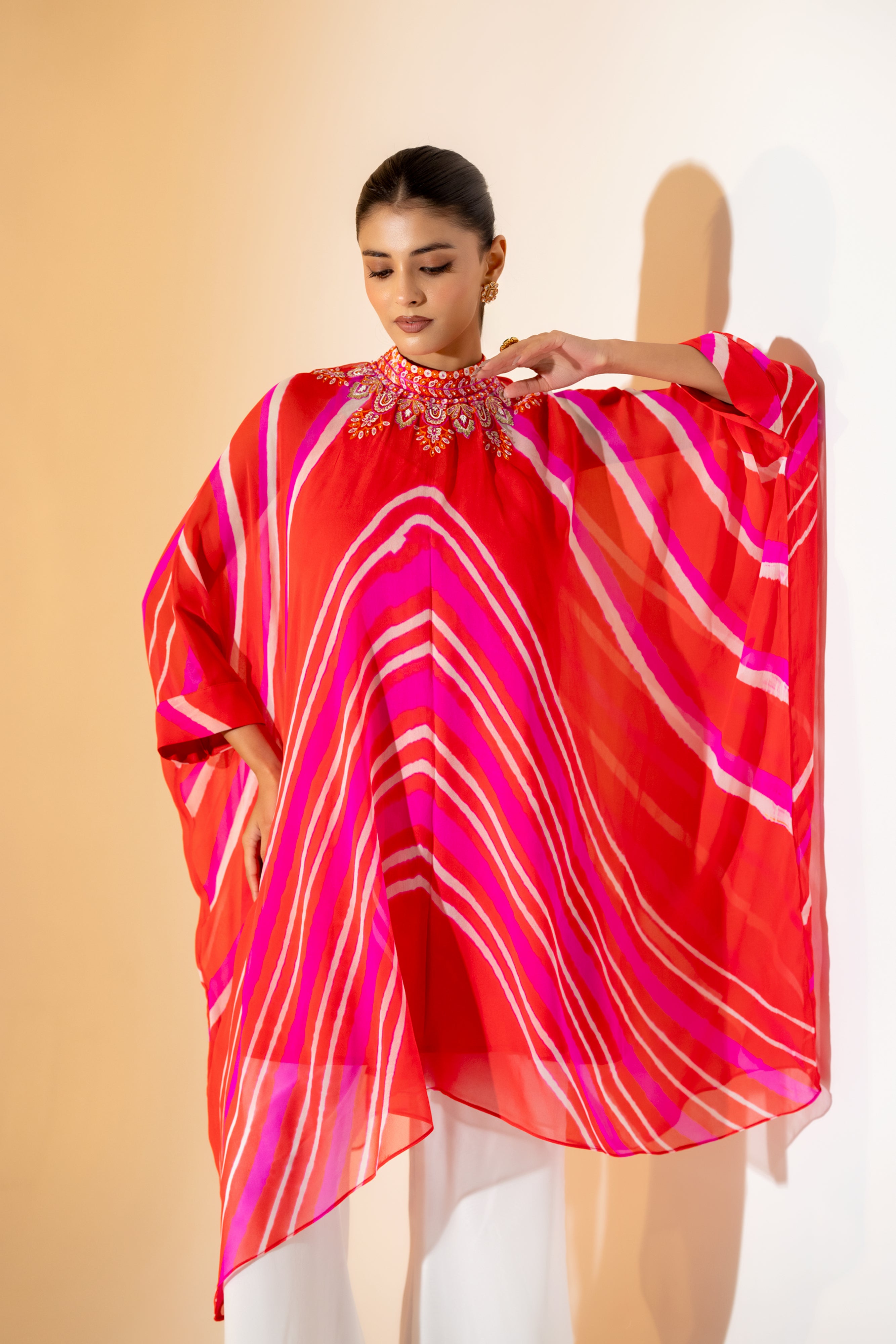 ORANGE AND PINK LEHERIYA KAFTAN TOP WITH EMBROIDERED NECKLINE & WHITE PANT.