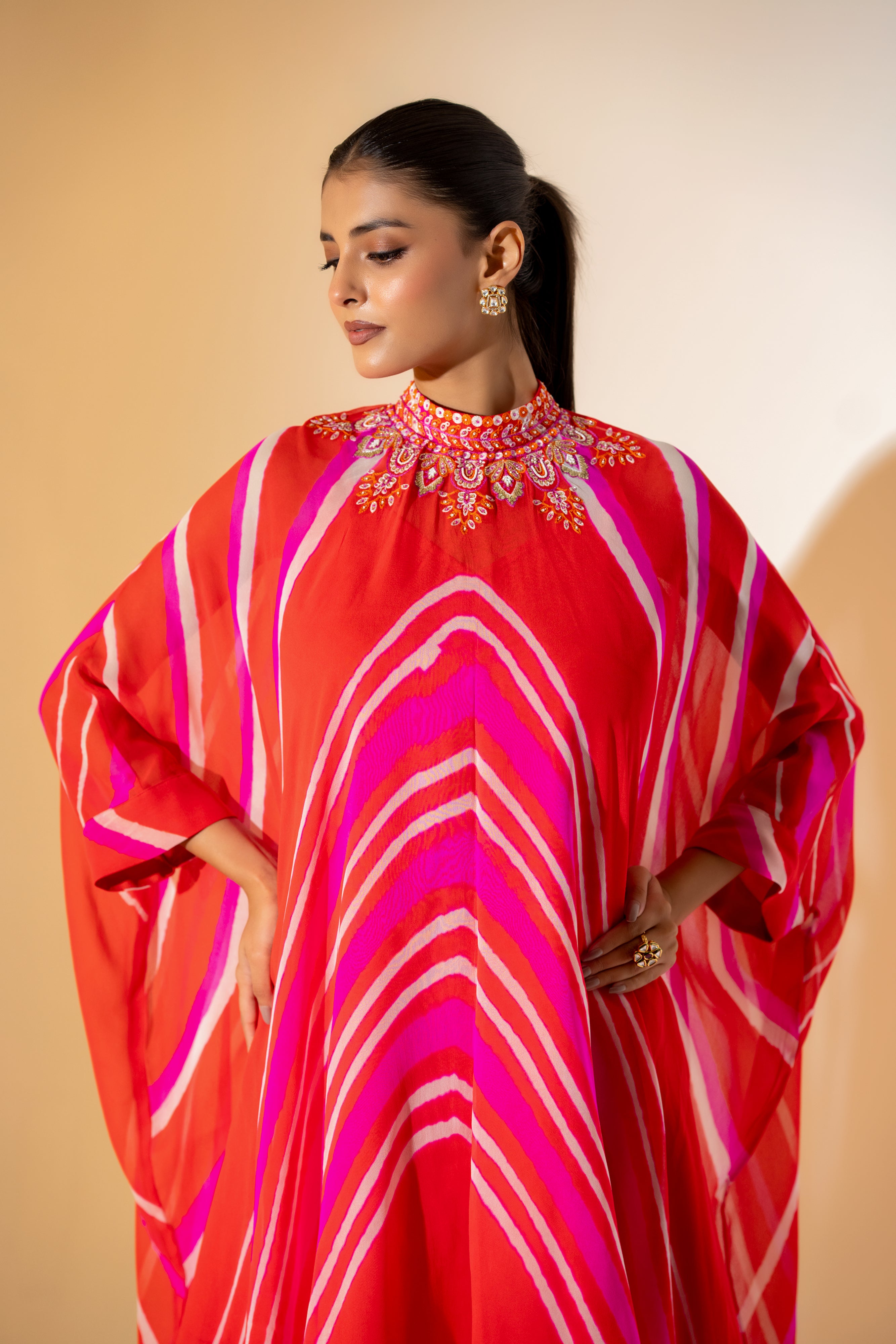 ORANGE AND PINK LEHERIYA KAFTAN TOP WITH EMBROIDERED NECKLINE & WHITE PANT.