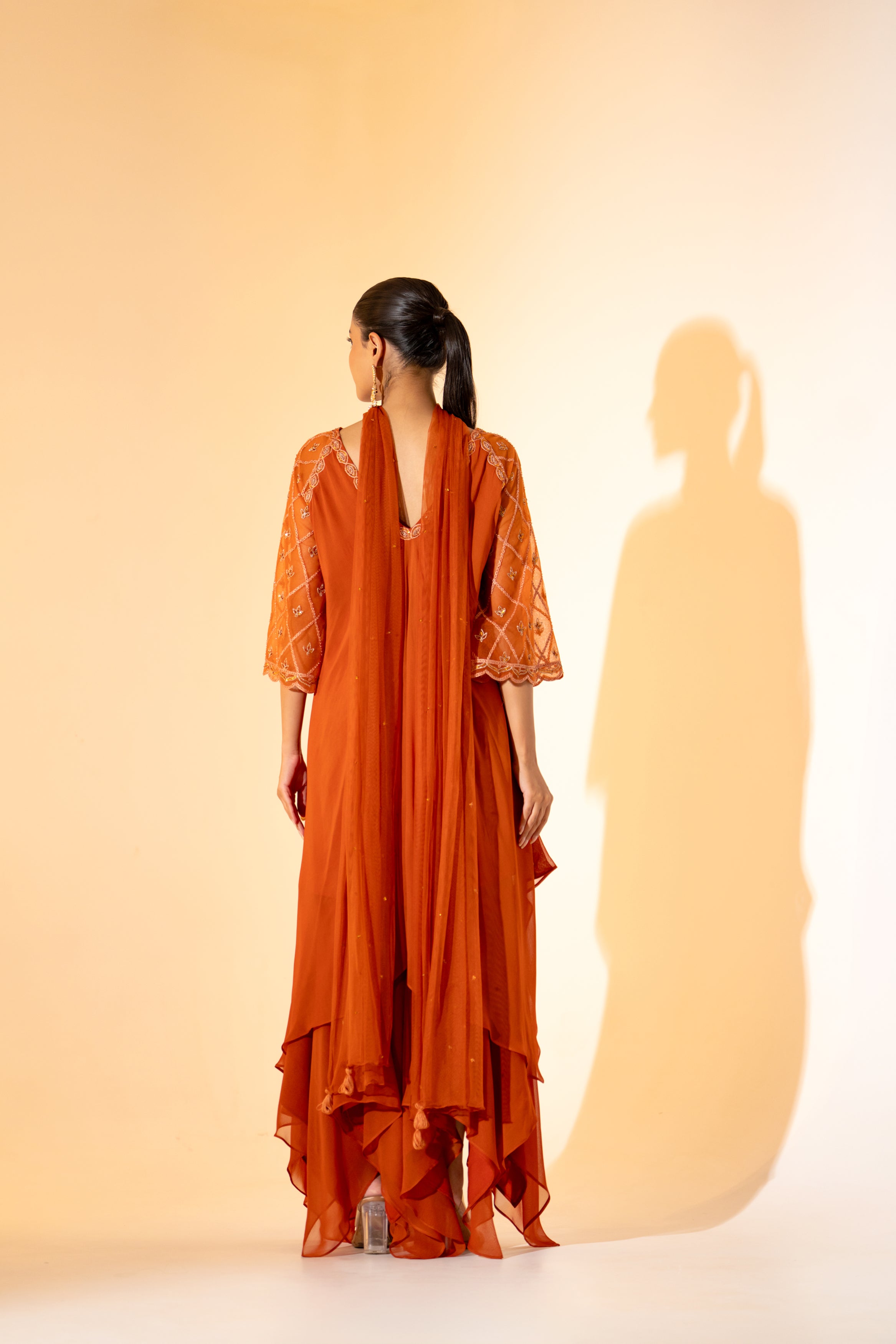 RUST ORANGE SAHARA- STYLE LAYERED DRESS WITH EMBROIDERED SLEEVES AND SCARF.