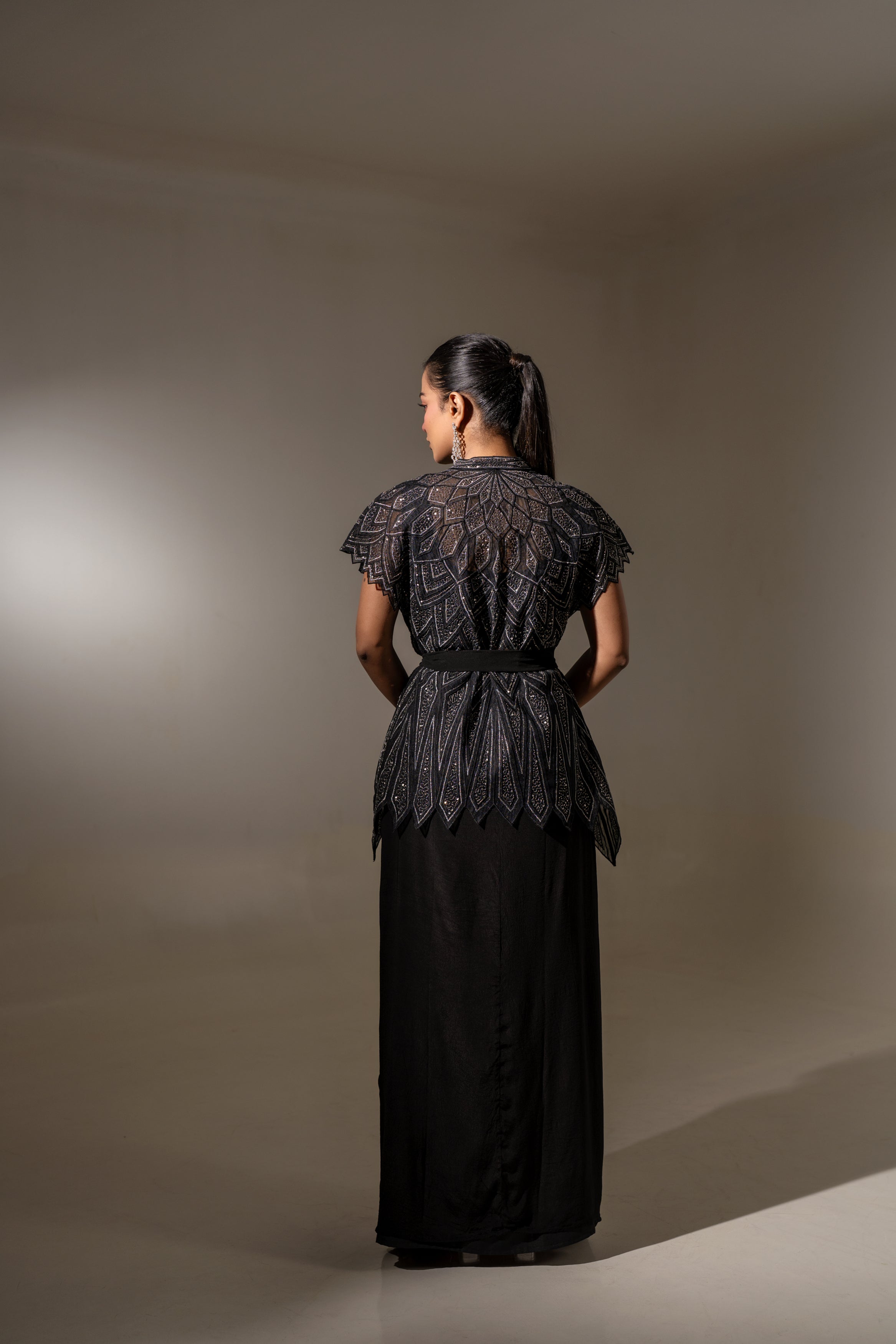 BLACK SKIRT & TOP WITH EMBELLISHED BELTED JACKET.