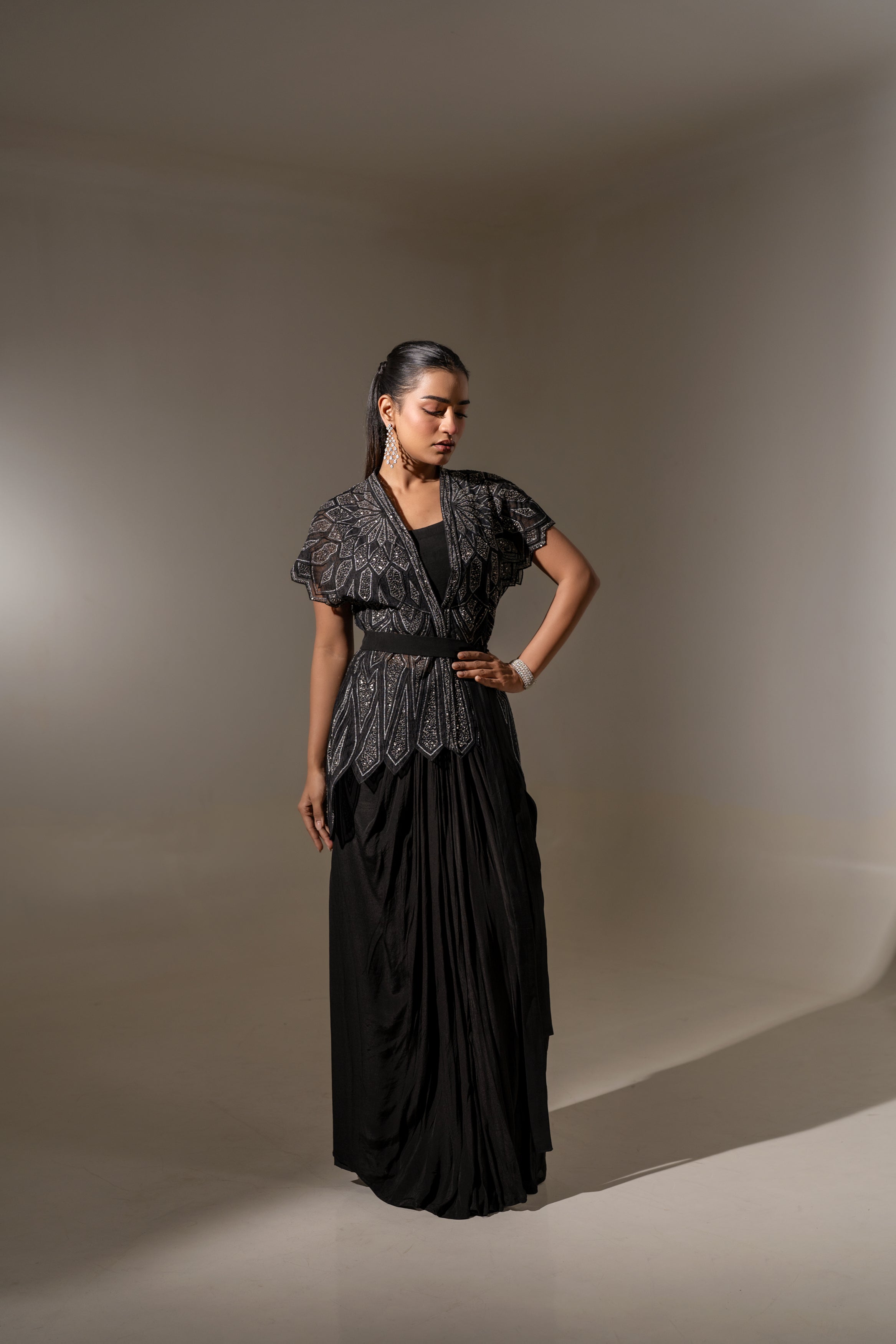BLACK SKIRT & TOP WITH EMBELLISHED BELTED JACKET.
