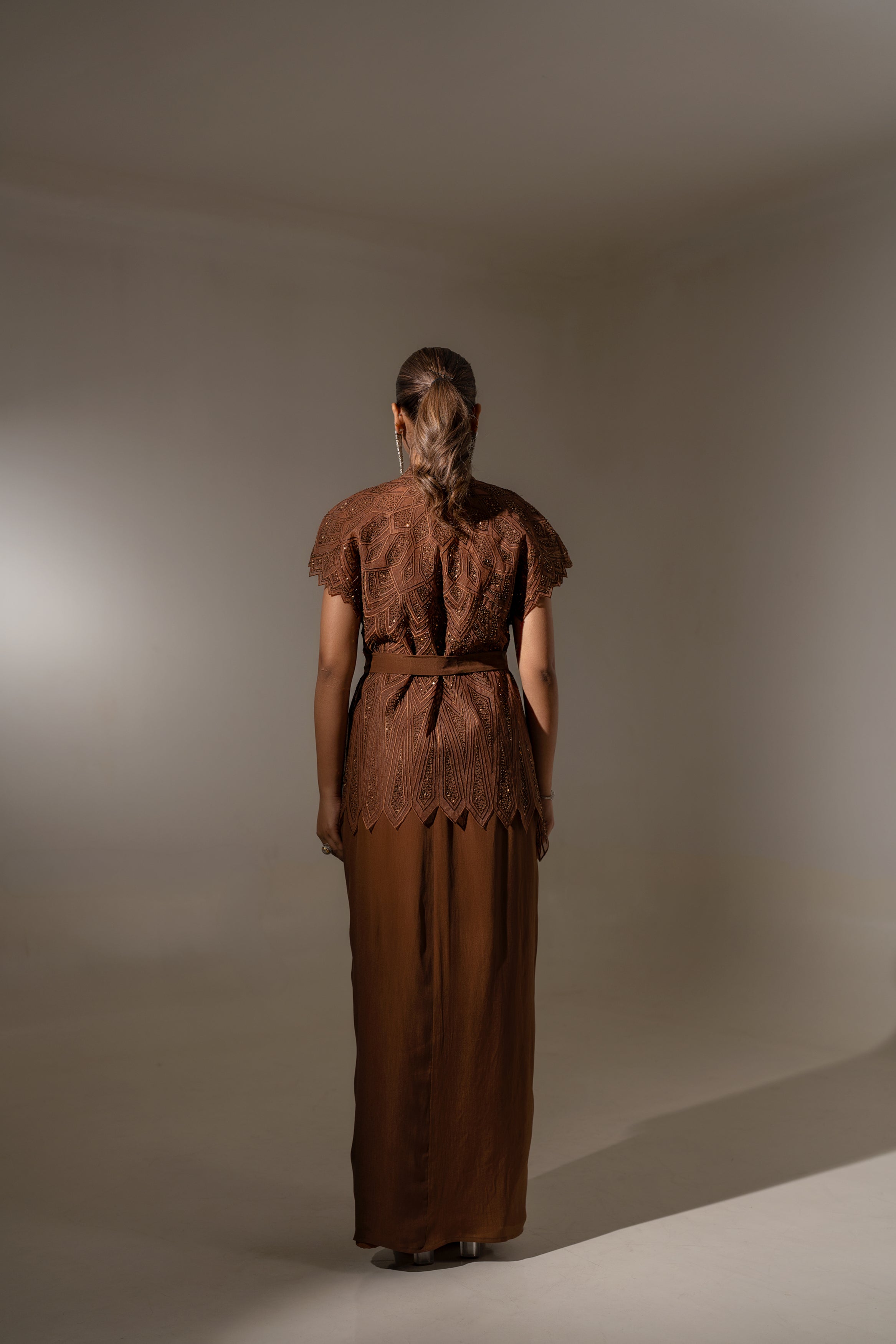 BROWN SKIRT & TOP WITH EMBELLISHED BELTED JACKET.