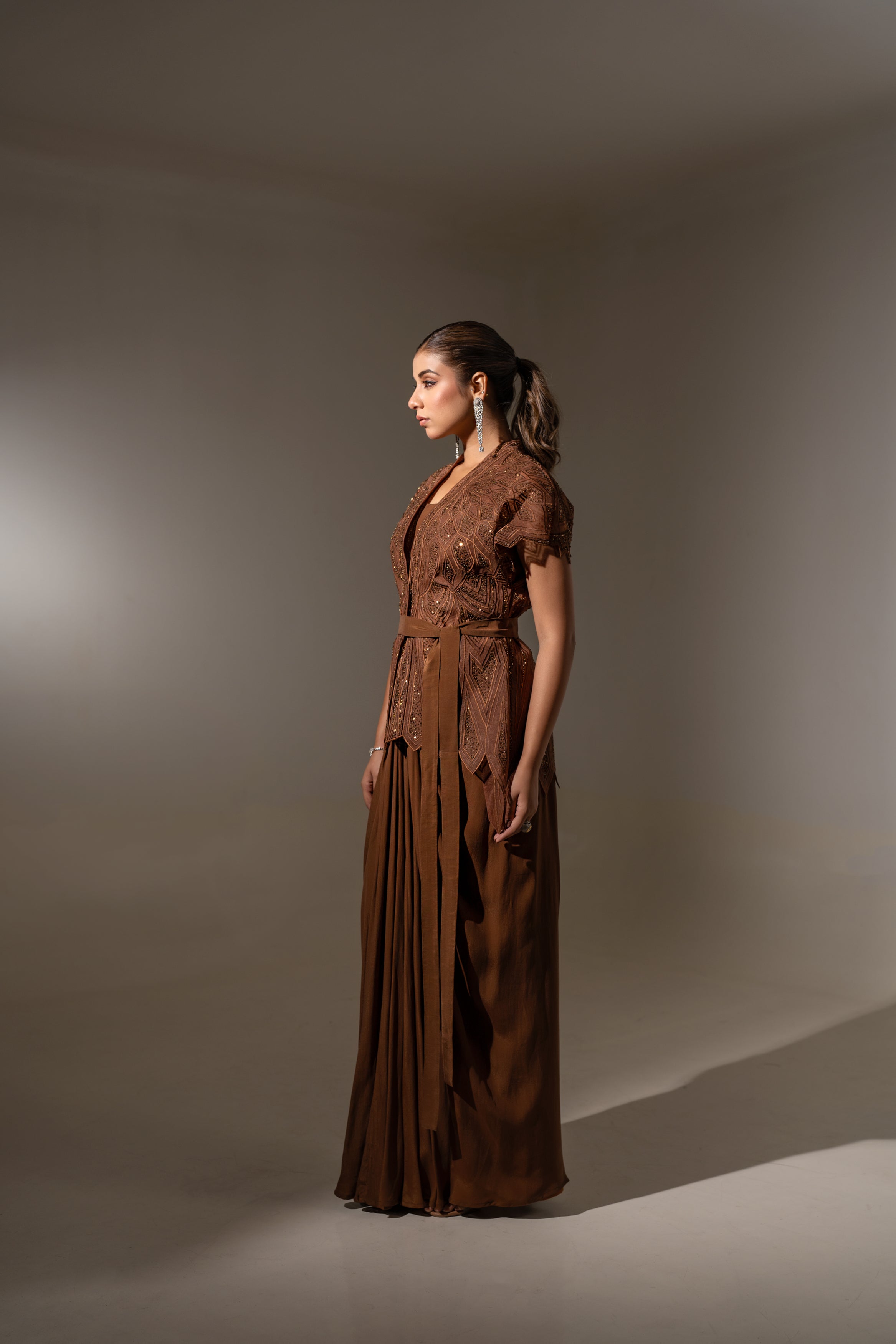BROWN SKIRT & TOP WITH EMBELLISHED BELTED JACKET.