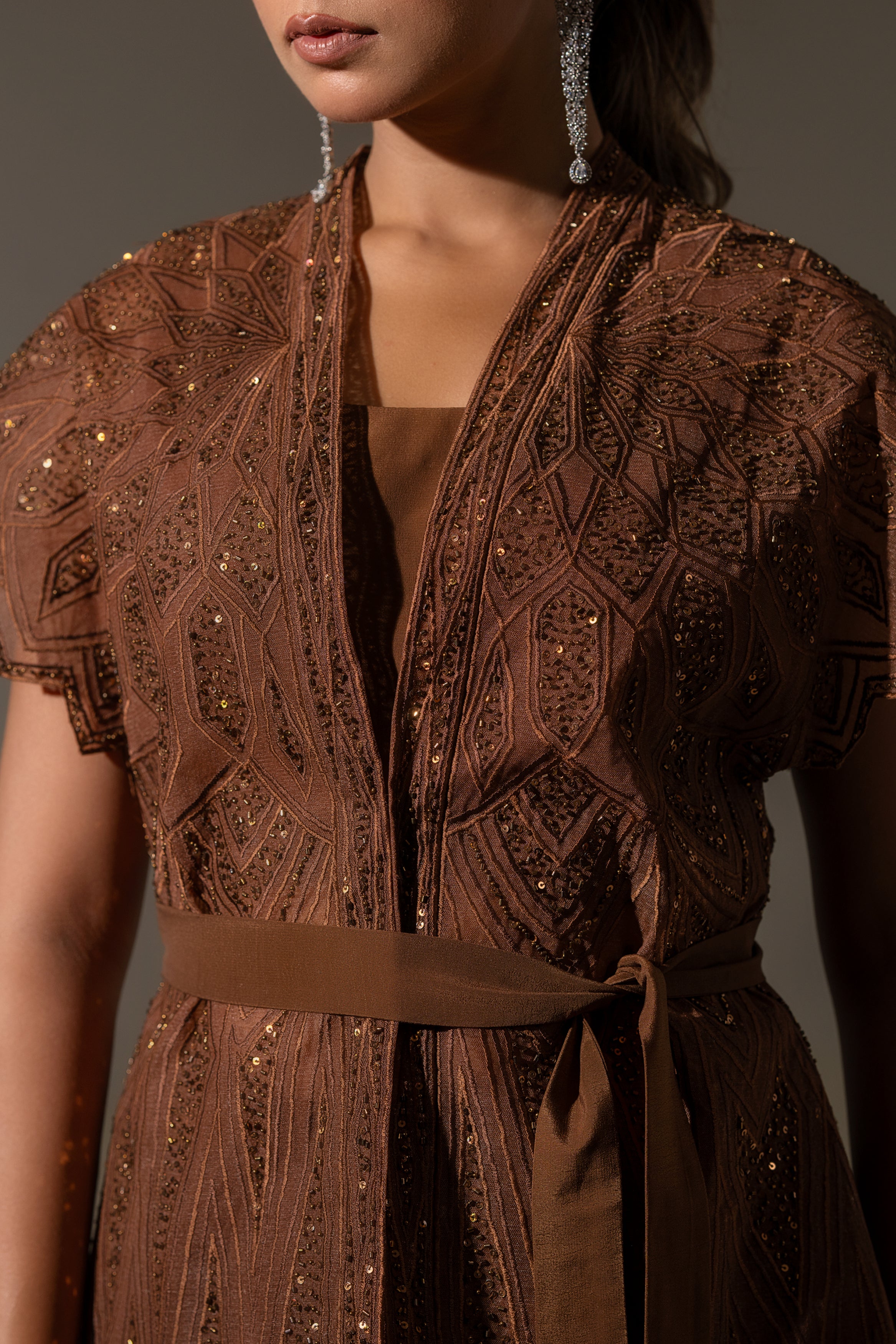 BROWN SKIRT & TOP WITH EMBELLISHED BELTED JACKET.