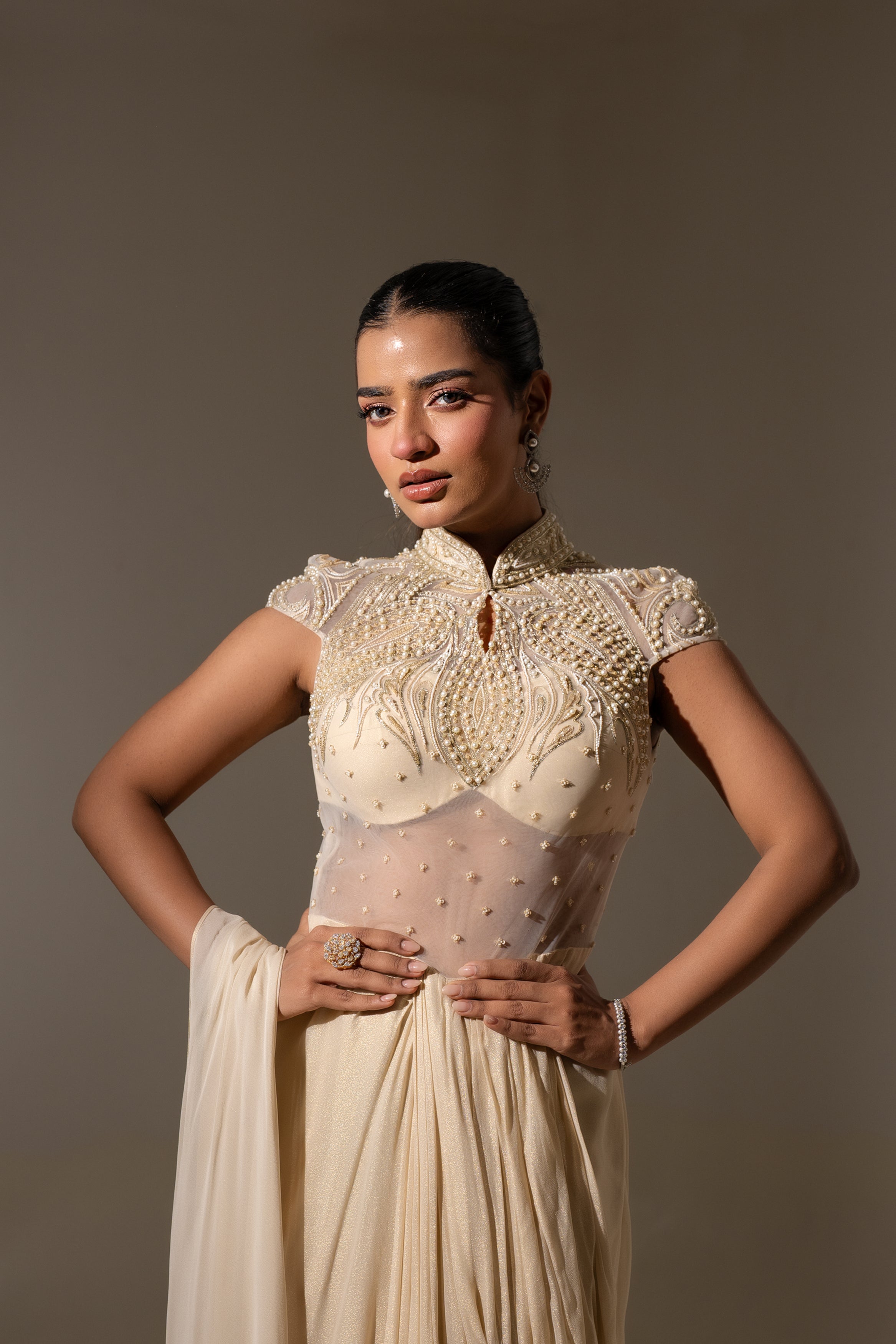OFF WHITE EMBELLISHED SAREE WITH HIGH-NECK BODICE.