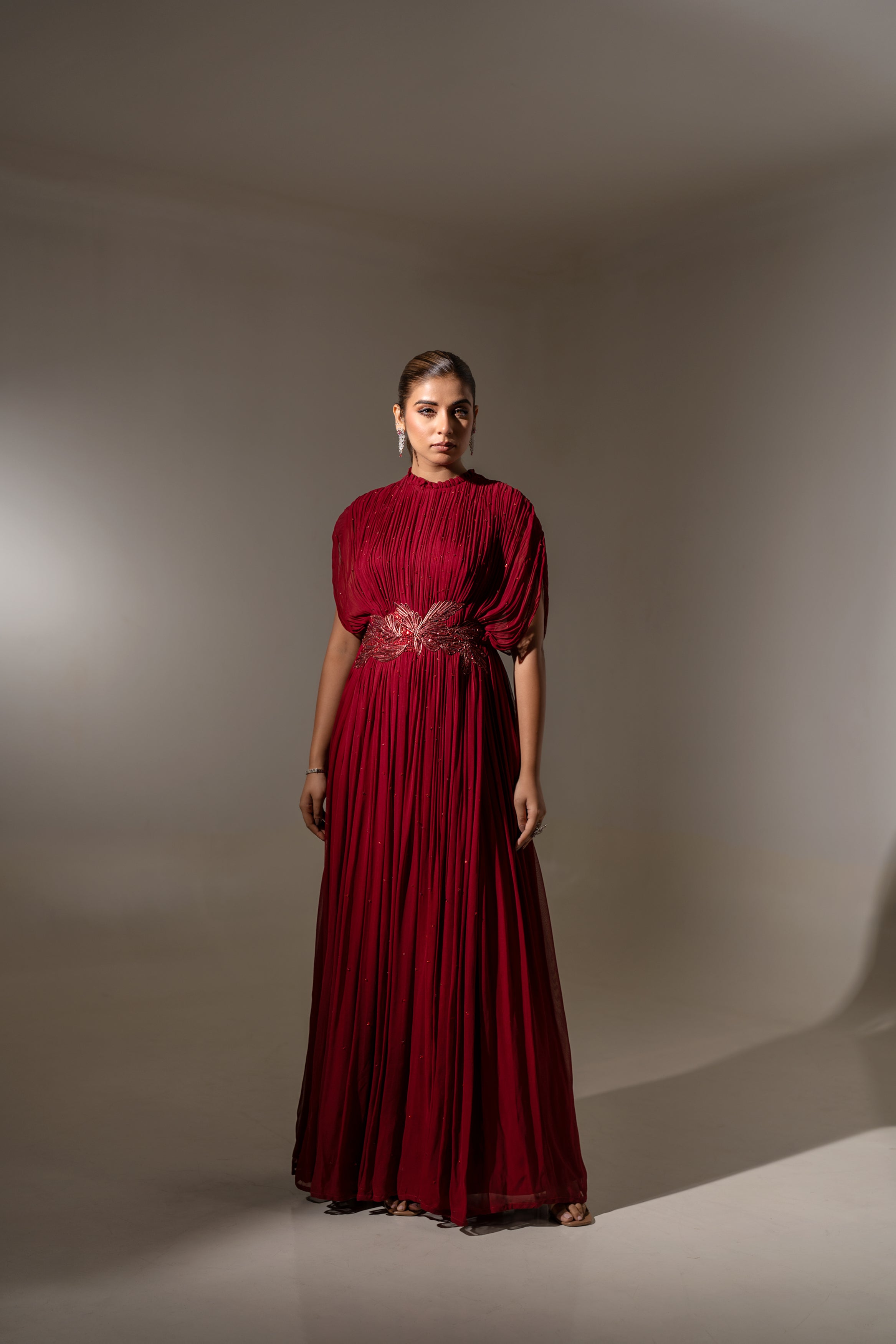 MAROON WIRE EMBELLISHED PLEATED GOWN WITH SHEER SLEEVES.
