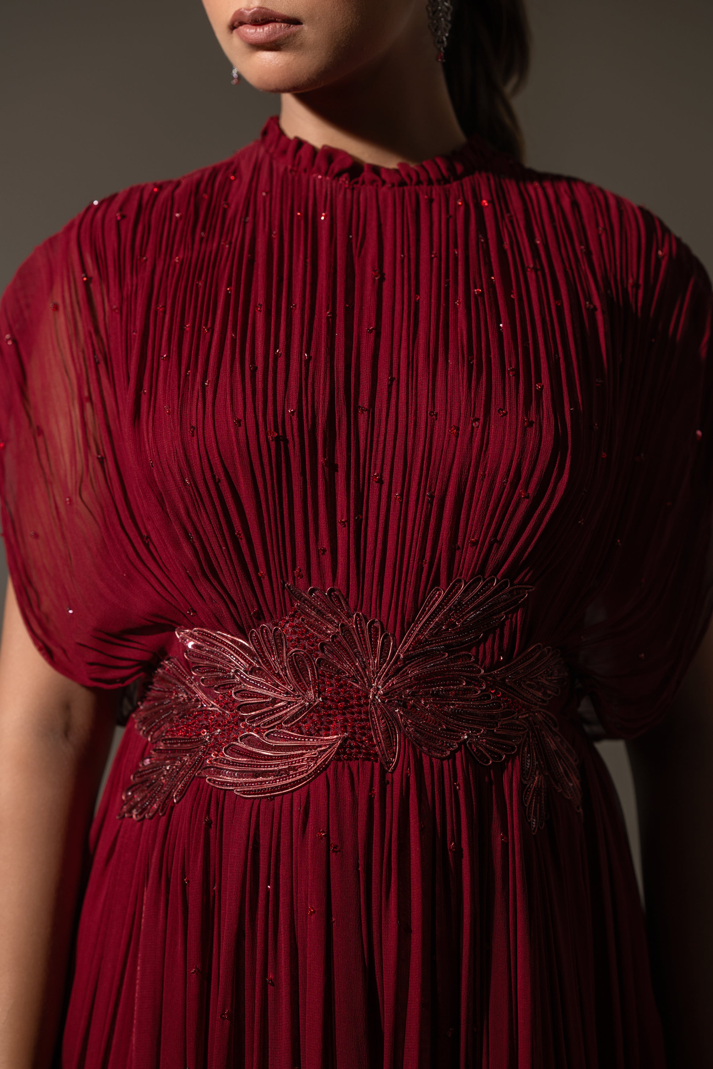 MAROON WIRE EMBELLISHED PLEATED GOWN WITH SHEER SLEEVES.