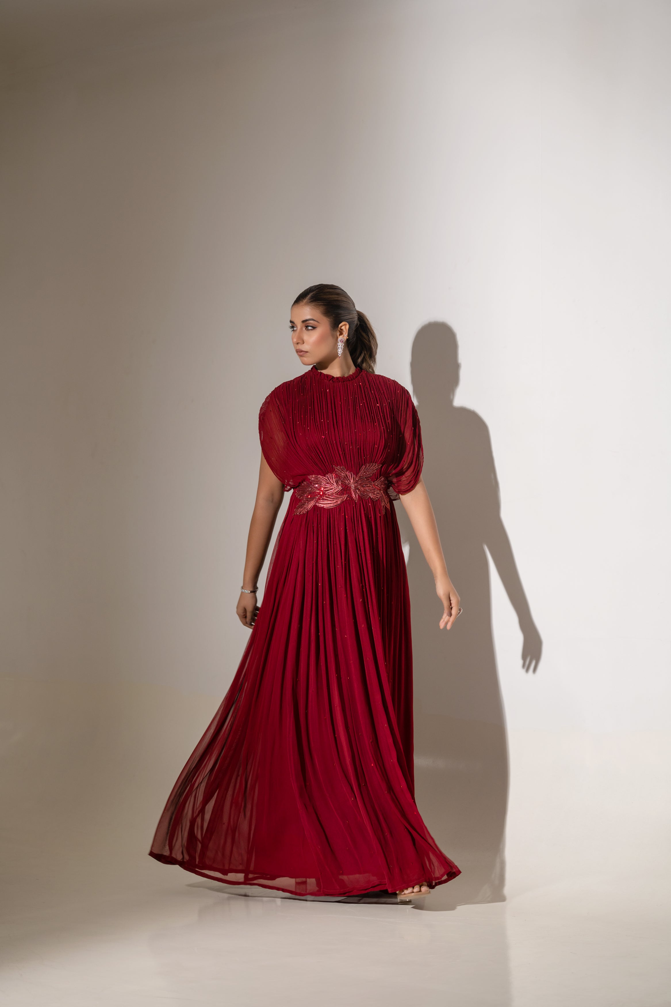 MAROON WIRE EMBELLISHED PLEATED GOWN WITH SHEER SLEEVES.