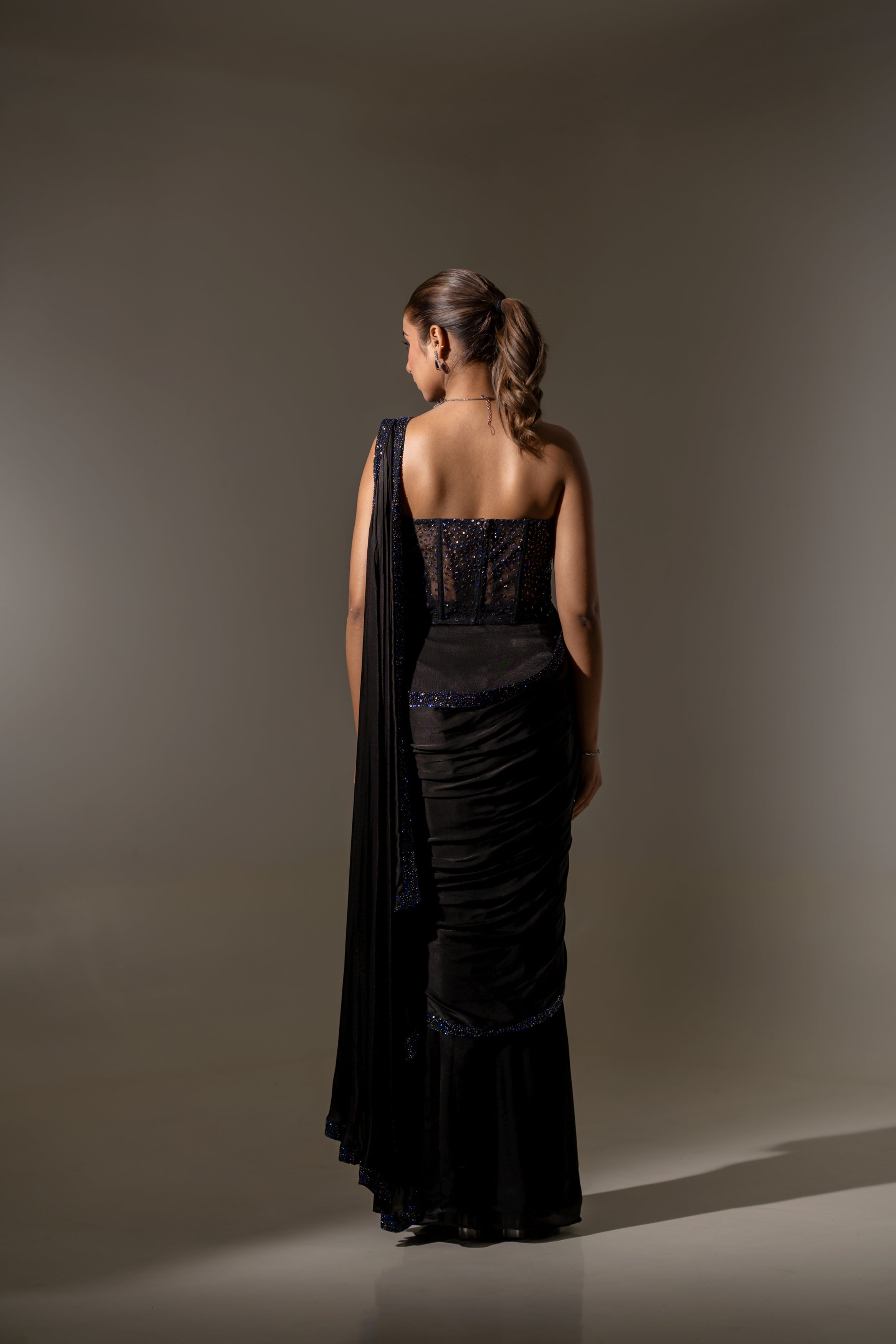 BLACK SEQUIN AND BEAD EMBELLISHED DRAPED SAREE WITH WIRE-WORK BUSTIER.