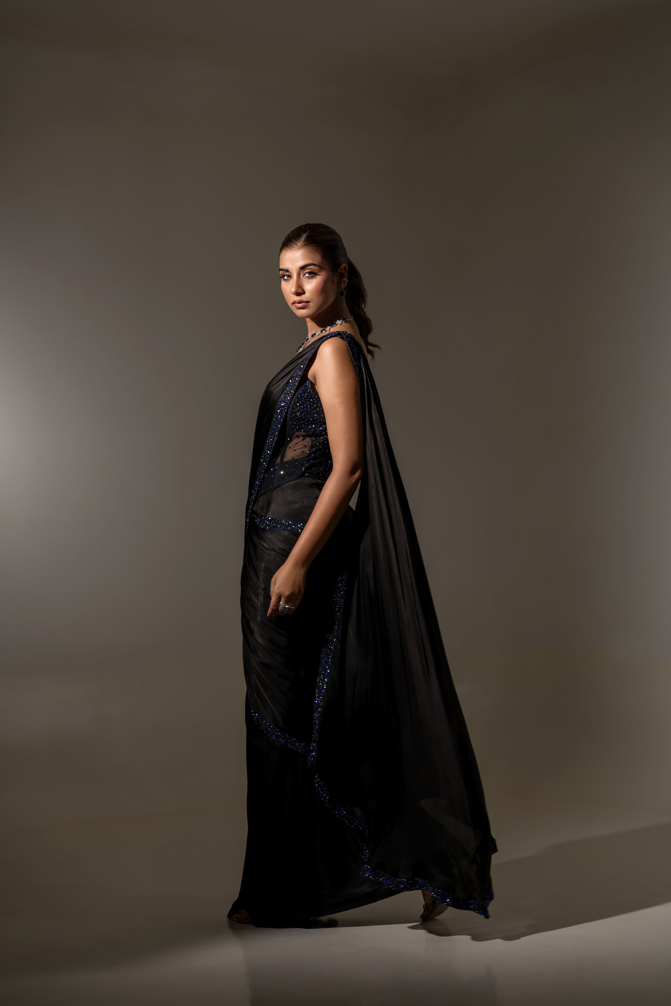 BLACK SEQUIN AND BEAD EMBELLISHED DRAPED SAREE WITH WIRE-WORK BUSTIER.