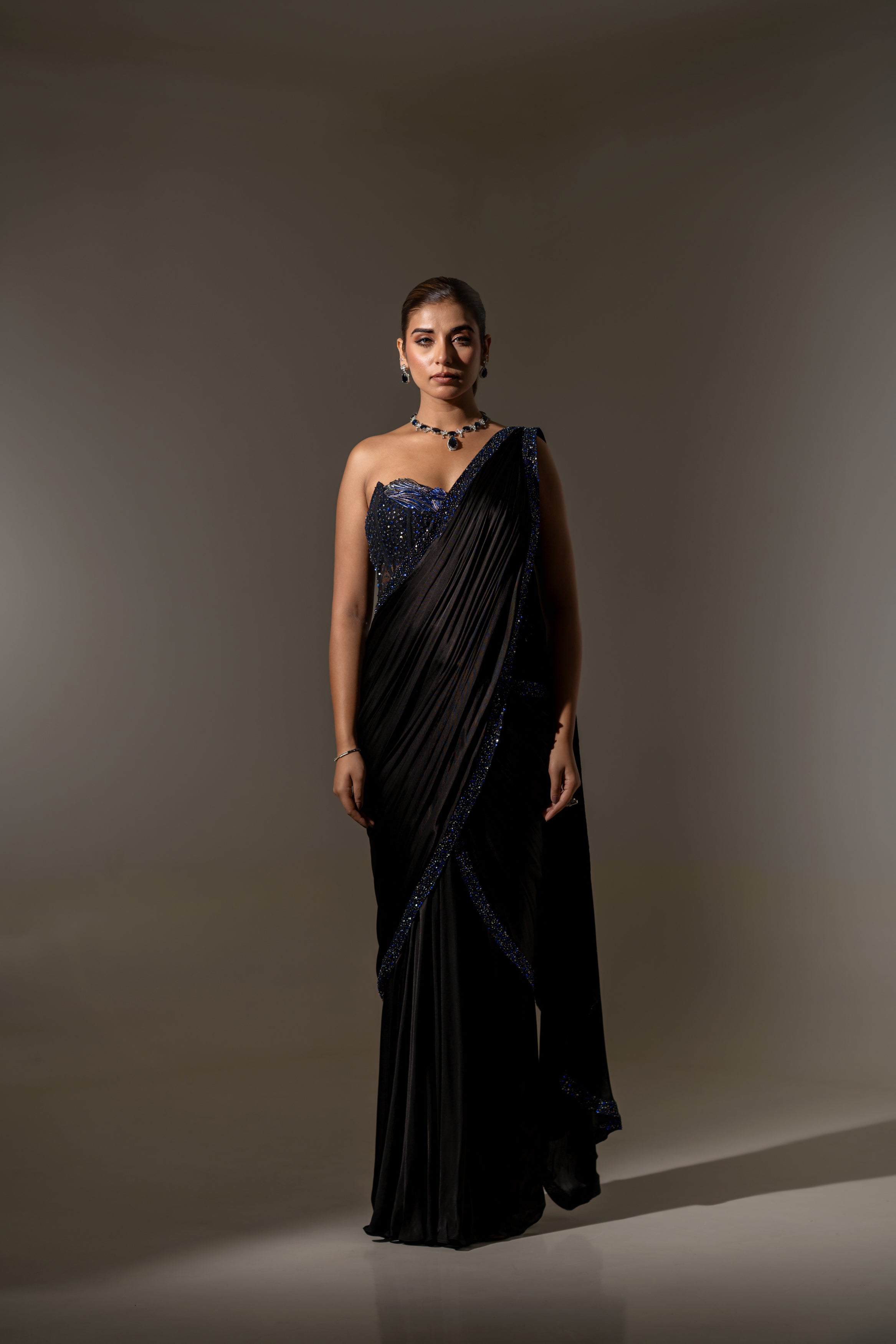 BLACK SEQUIN AND BEAD EMBELLISHED DRAPED SAREE WITH WIRE-WORK BUSTIER.