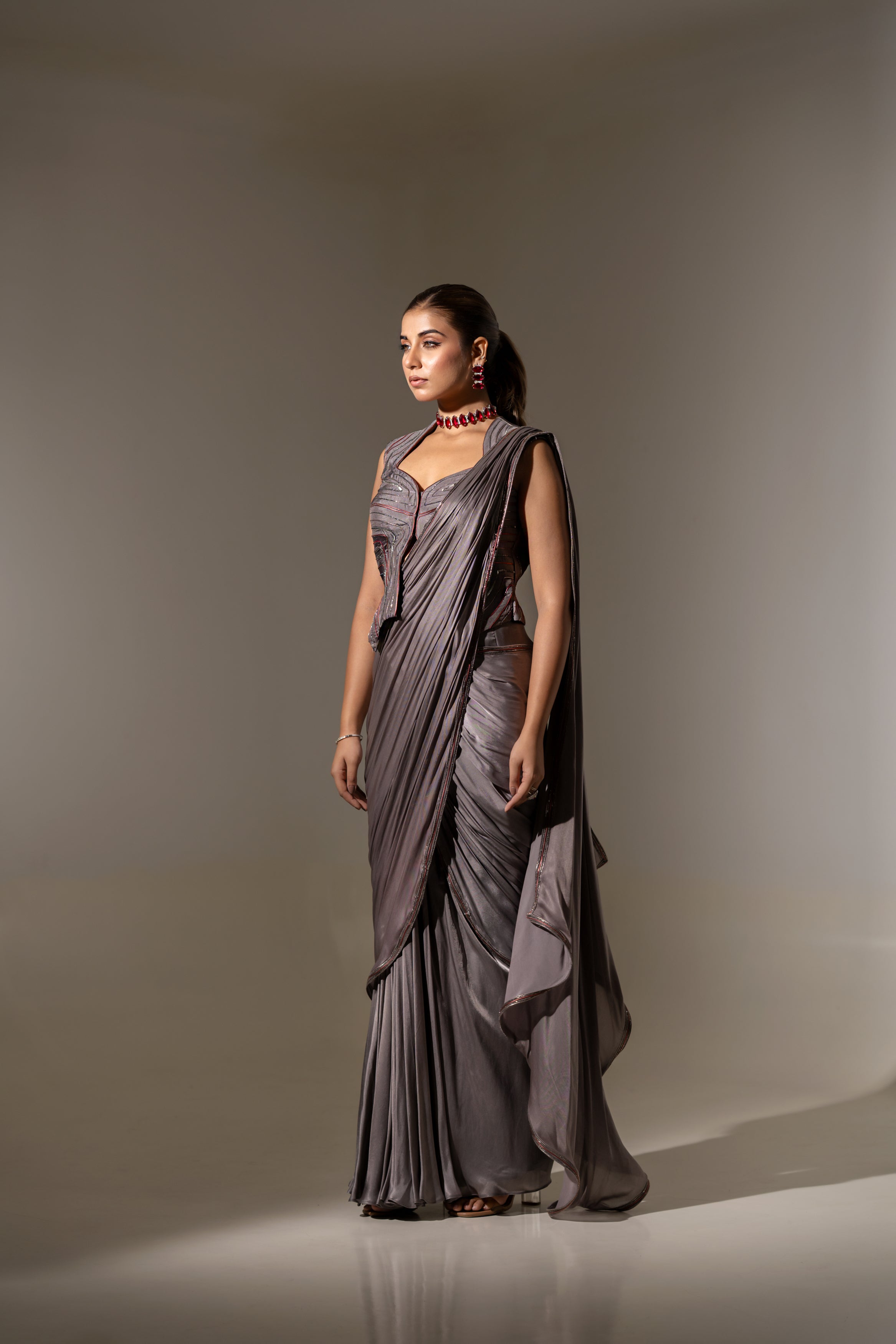 GREY SEQUIN AND EMBELLISHED PRE-DRAPED SAREE WITH DESIGNER CUT-OUT BLOUSE.