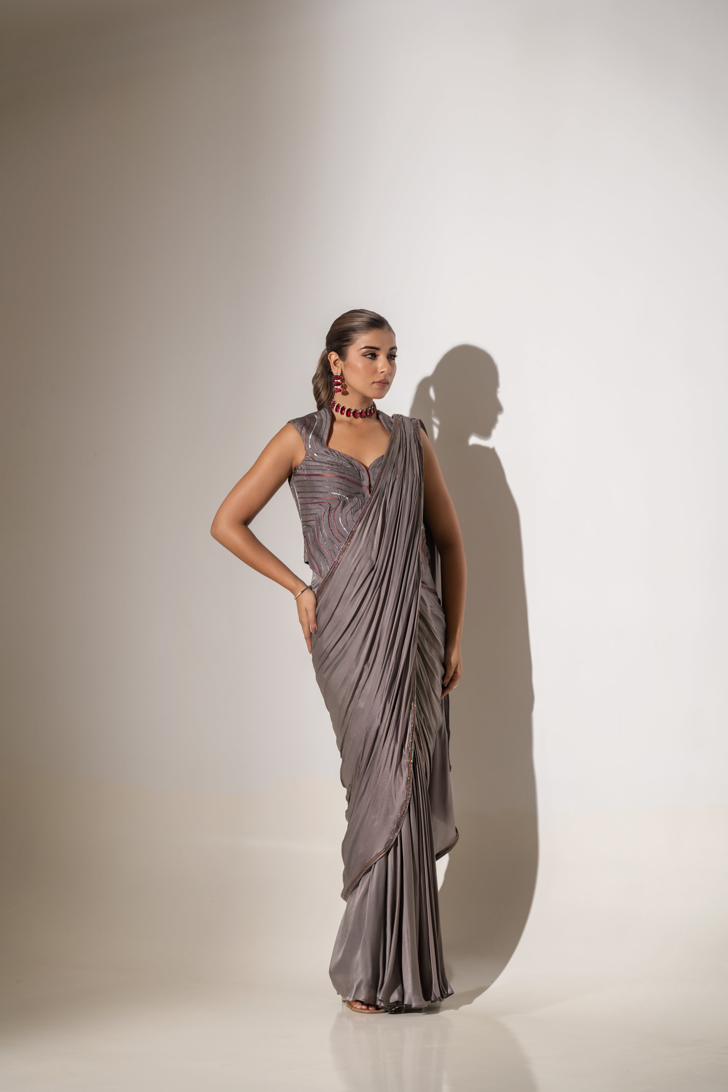 GREY SEQUIN AND EMBELLISHED PRE-DRAPED SAREE WITH DESIGNER CUT-OUT BLOUSE.