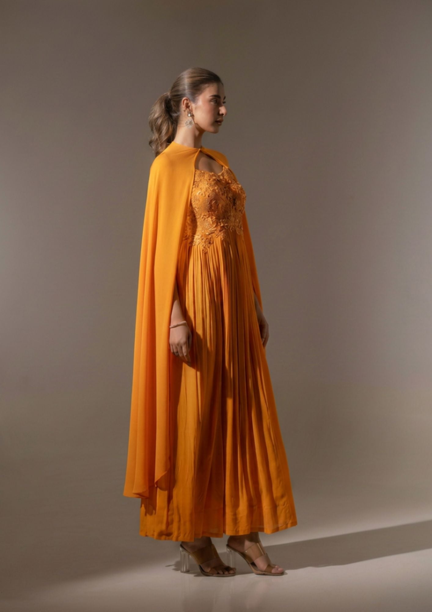 RUST EMBELLISHED CAPE STYLE PLEATED GOWN.