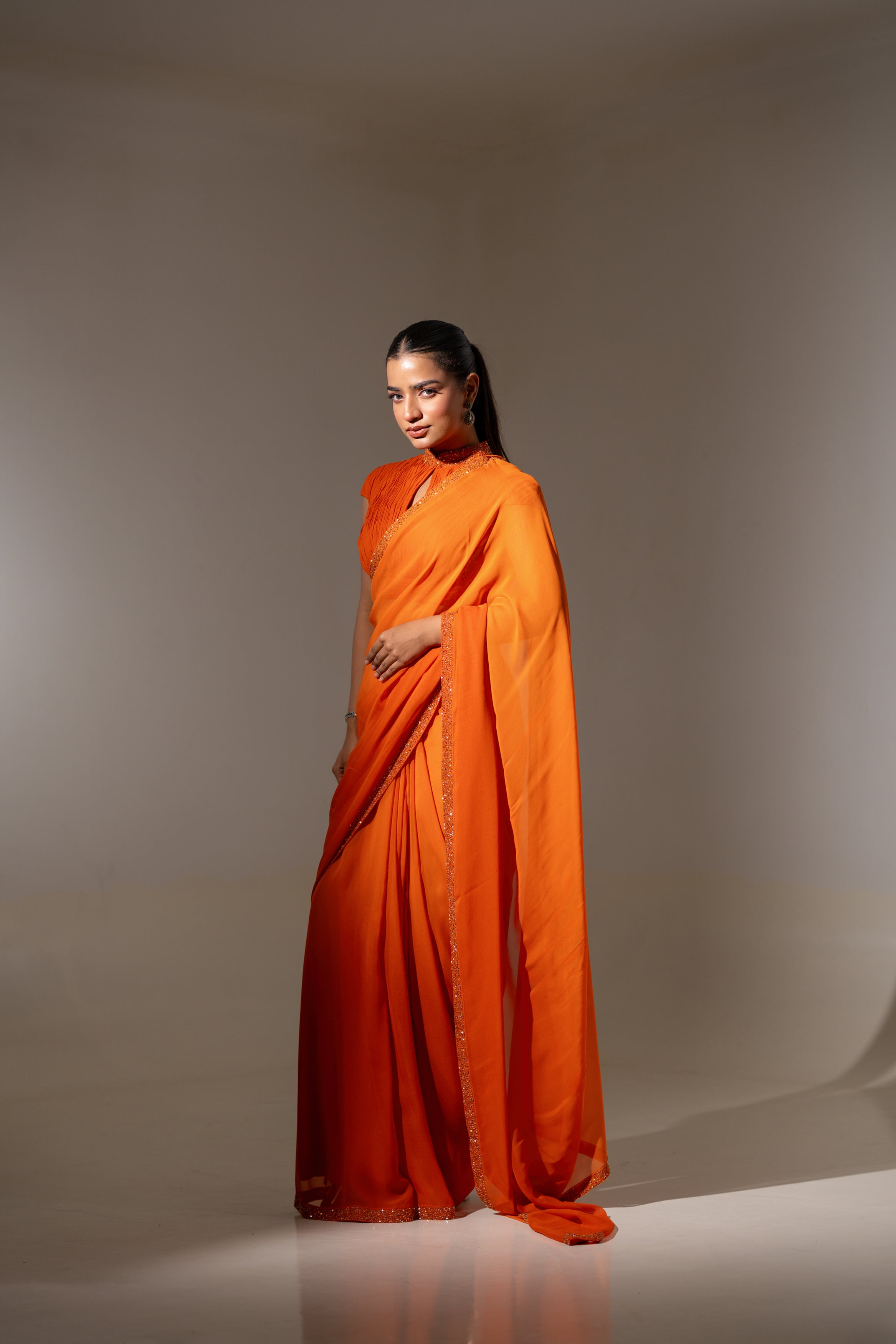 ORANGE DRAPED BLOUSE WITH OMBRE  SAREE.