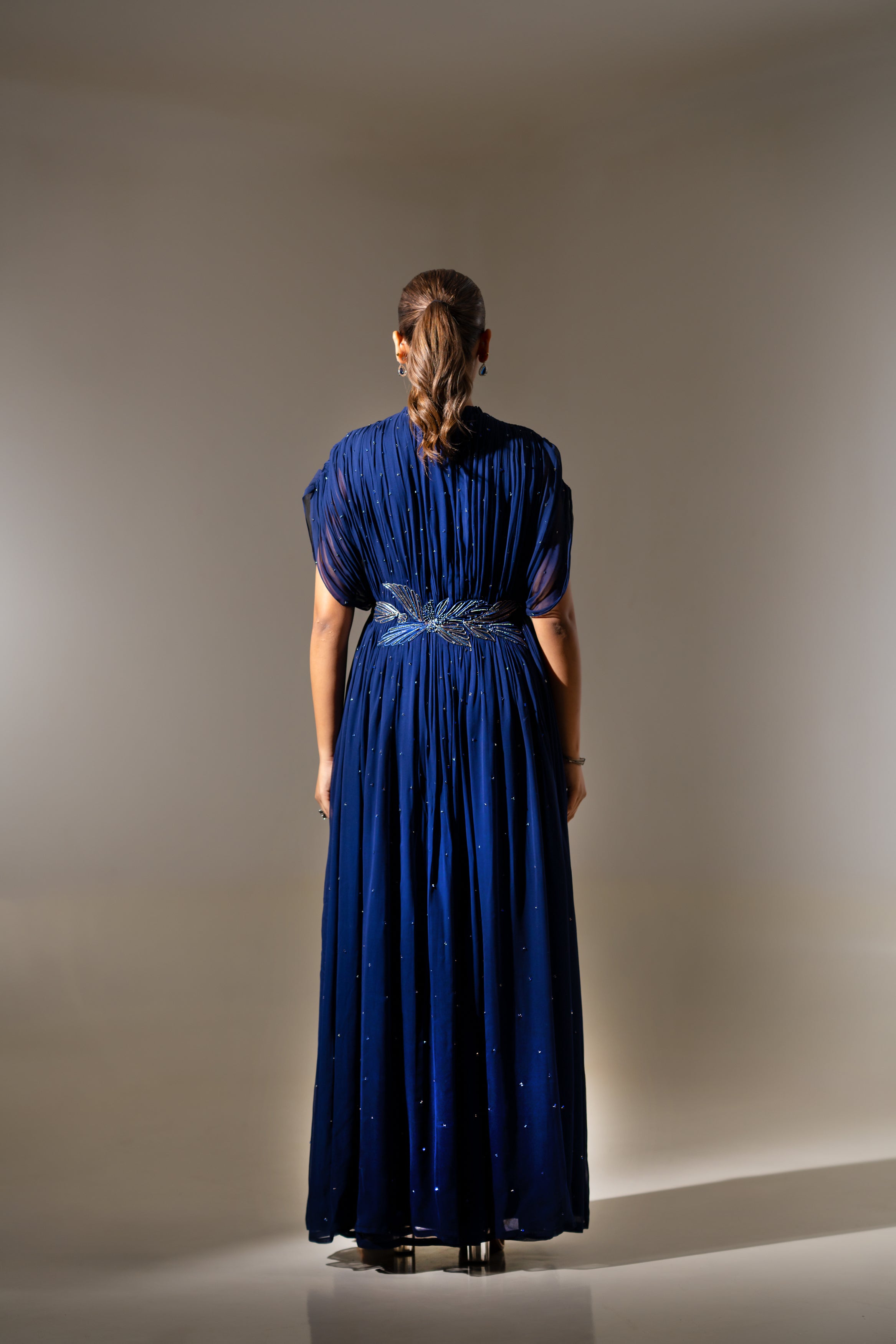 BLUE WIRE EMBELLISHED PLEATED GOWN WITH SHEER SLEEVES.