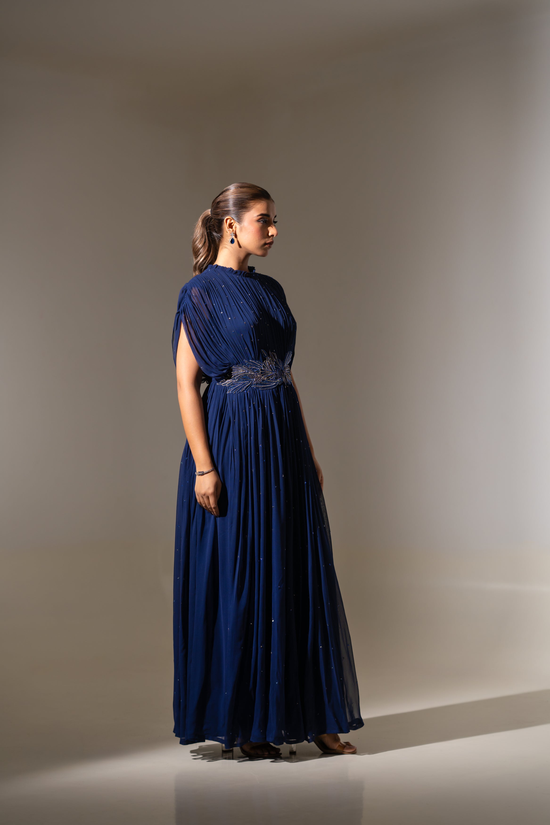 BLUE WIRE EMBELLISHED PLEATED GOWN WITH SHEER SLEEVES.