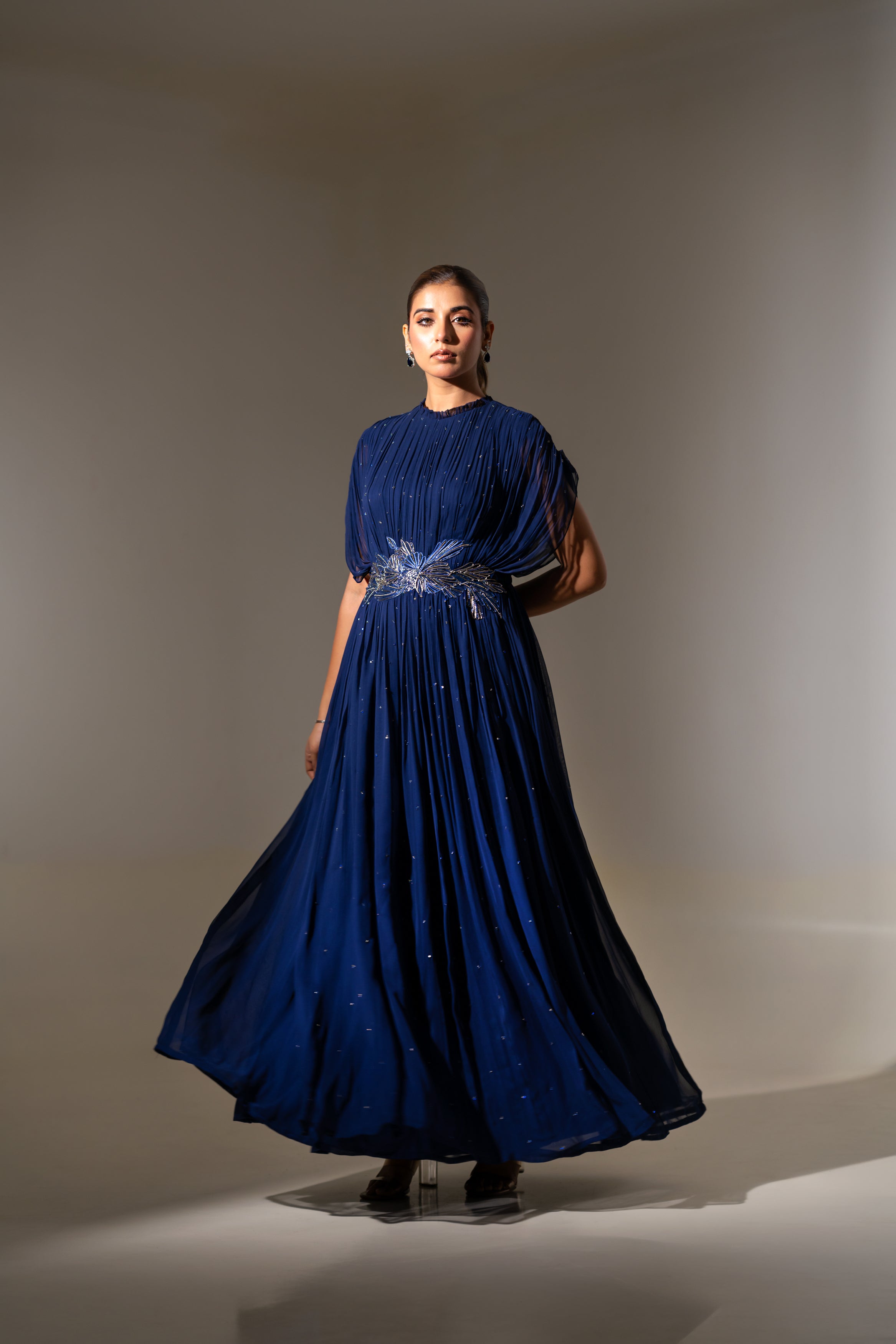 BLUE WIRE EMBELLISHED PLEATED GOWN WITH SHEER SLEEVES.