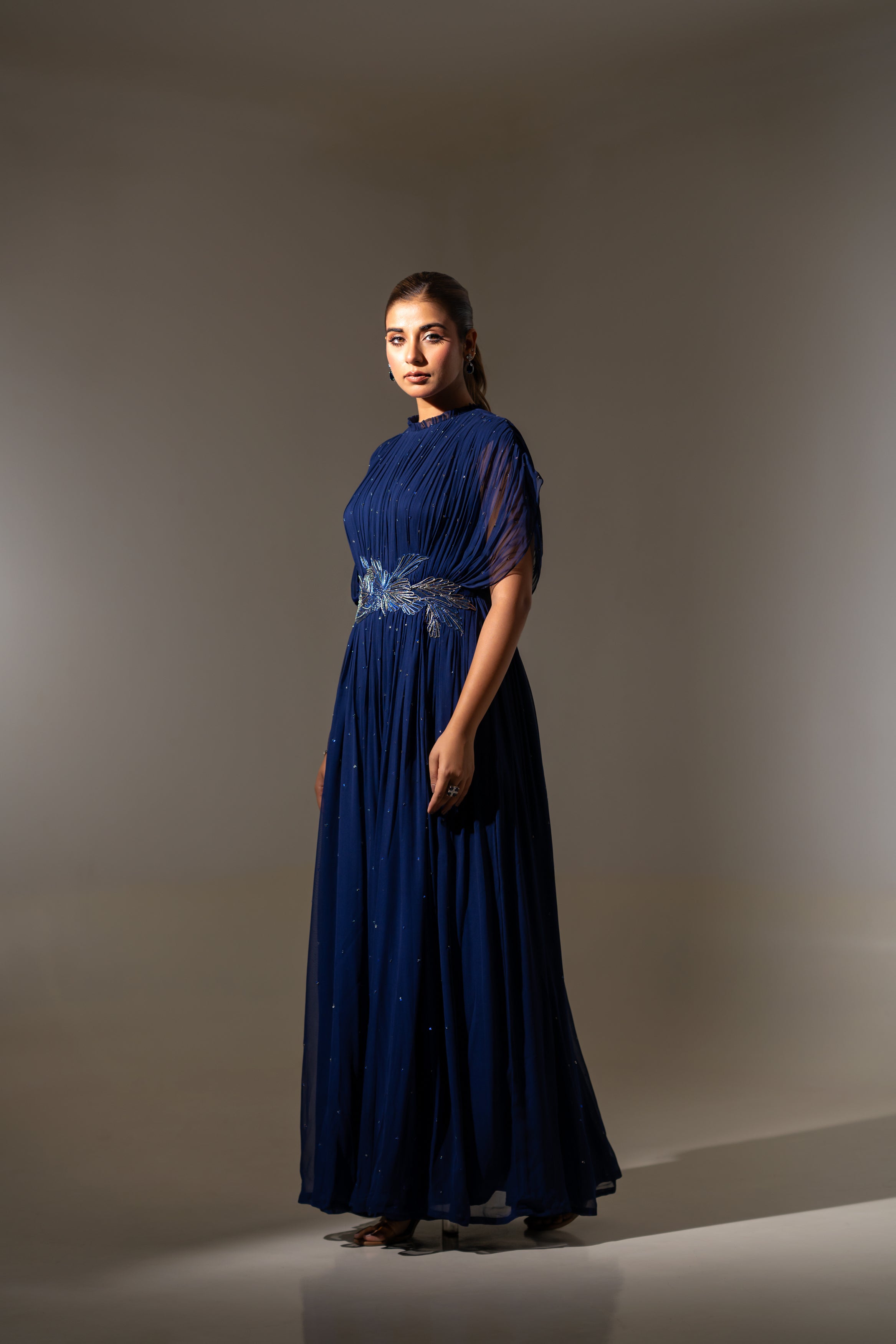 BLUE WIRE EMBELLISHED PLEATED GOWN WITH SHEER SLEEVES.