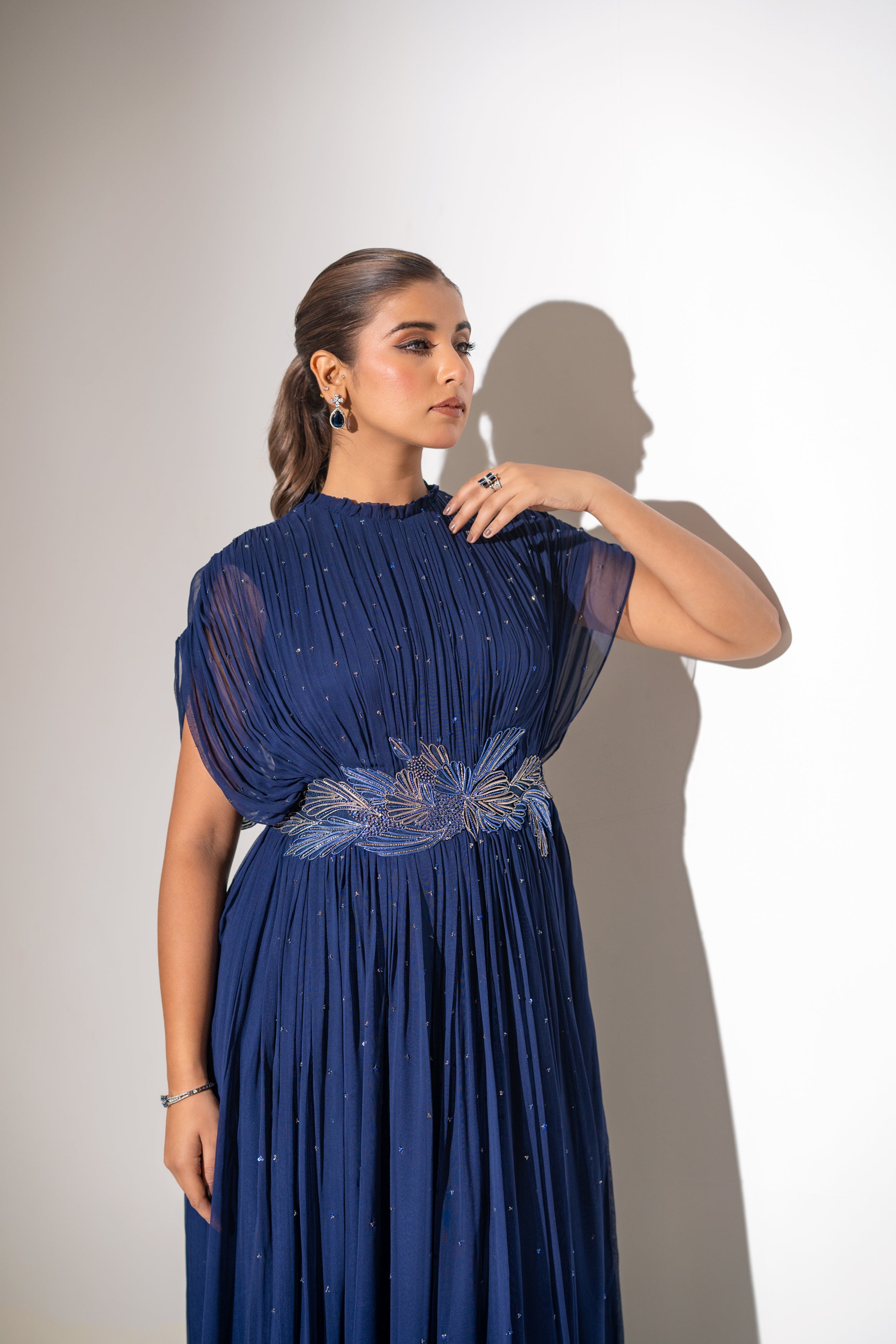 BLUE WIRE EMBELLISHED PLEATED GOWN WITH SHEER SLEEVES.