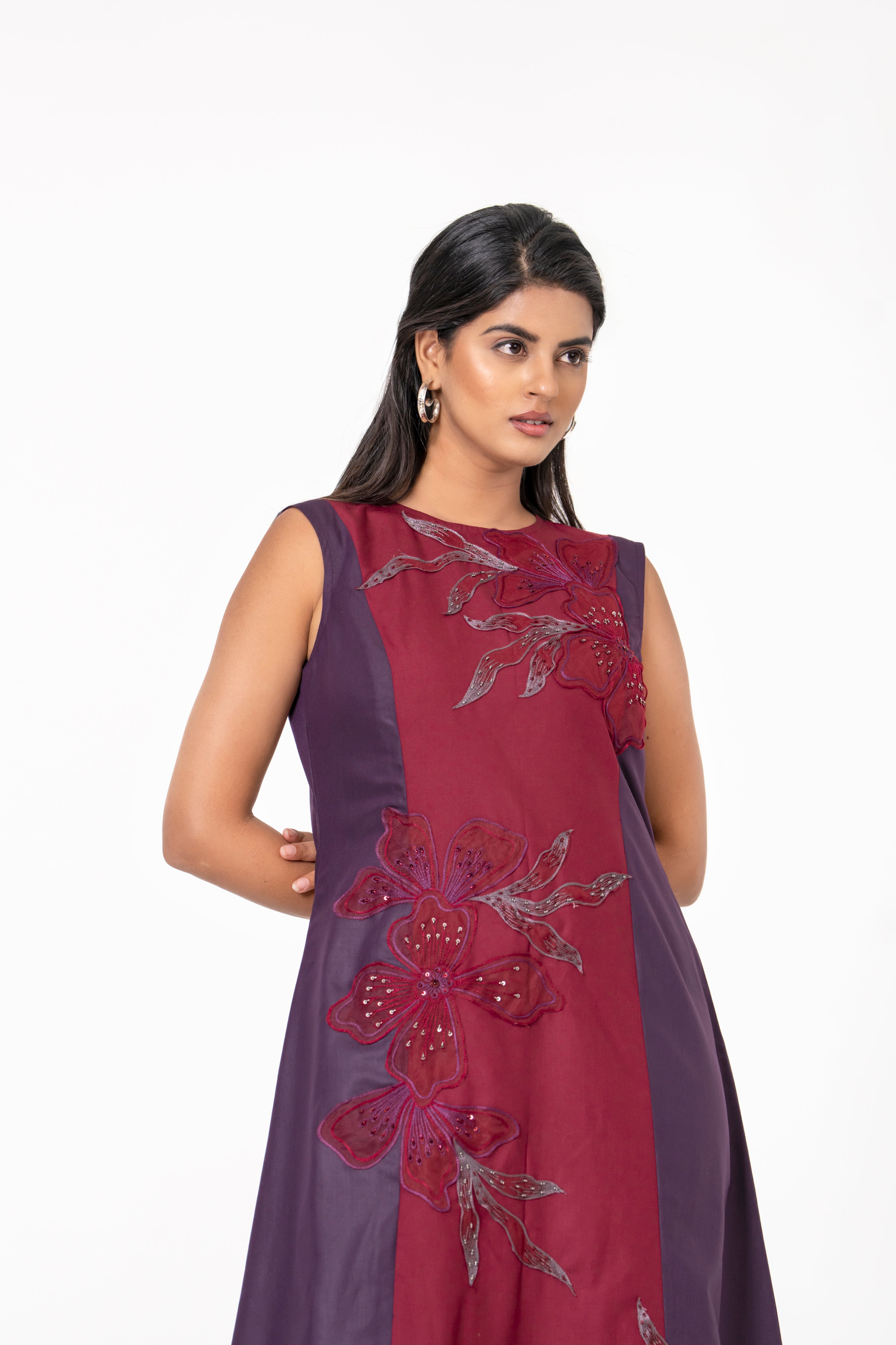 WINE AND MAROON SLEEVELESS A-LINE DRESS WITH FLORAL EMBROIDERED PANEL.