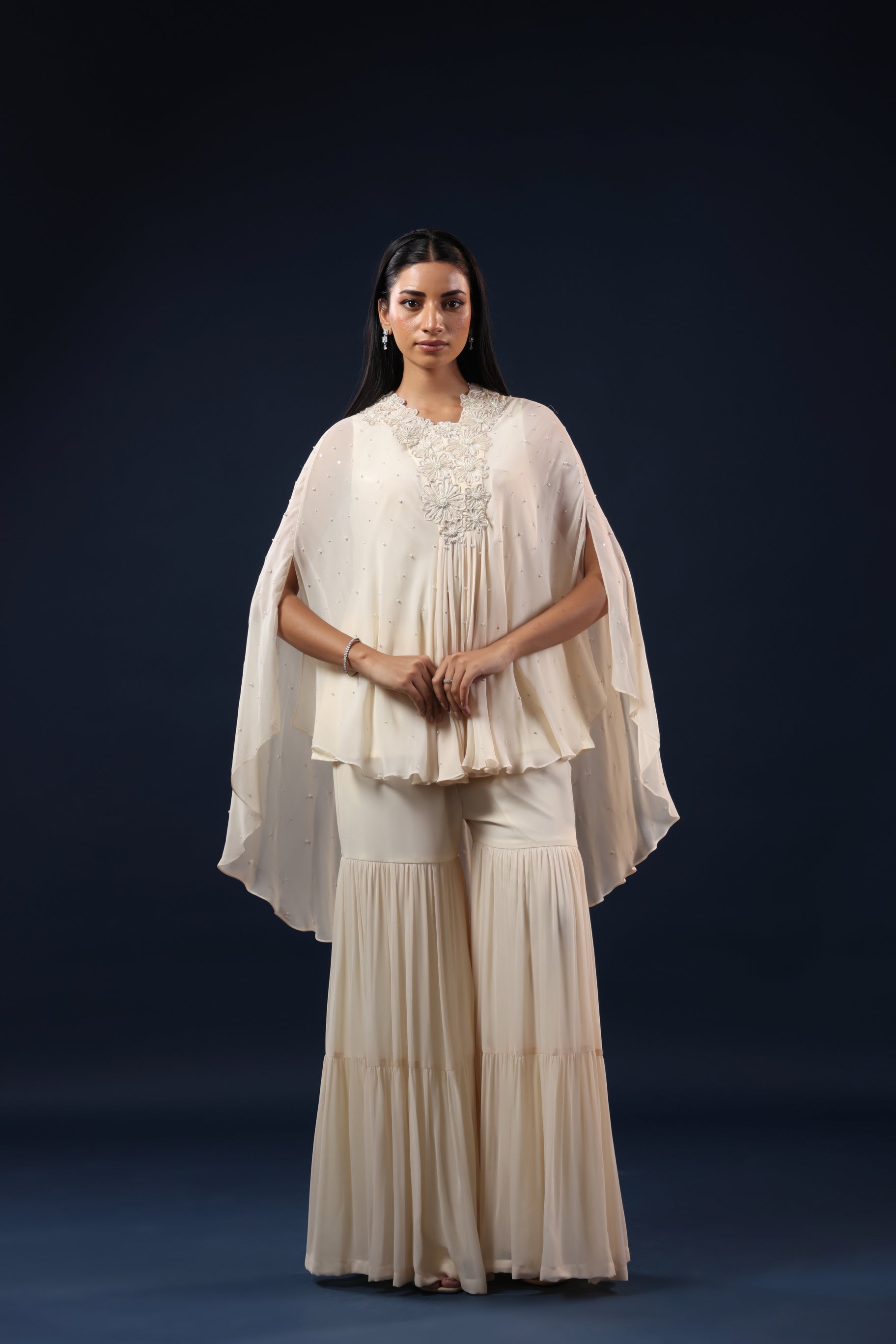 ELEGANT OFF WHITE CAPE TOP WITH FLARED PALAZZO PANTS.