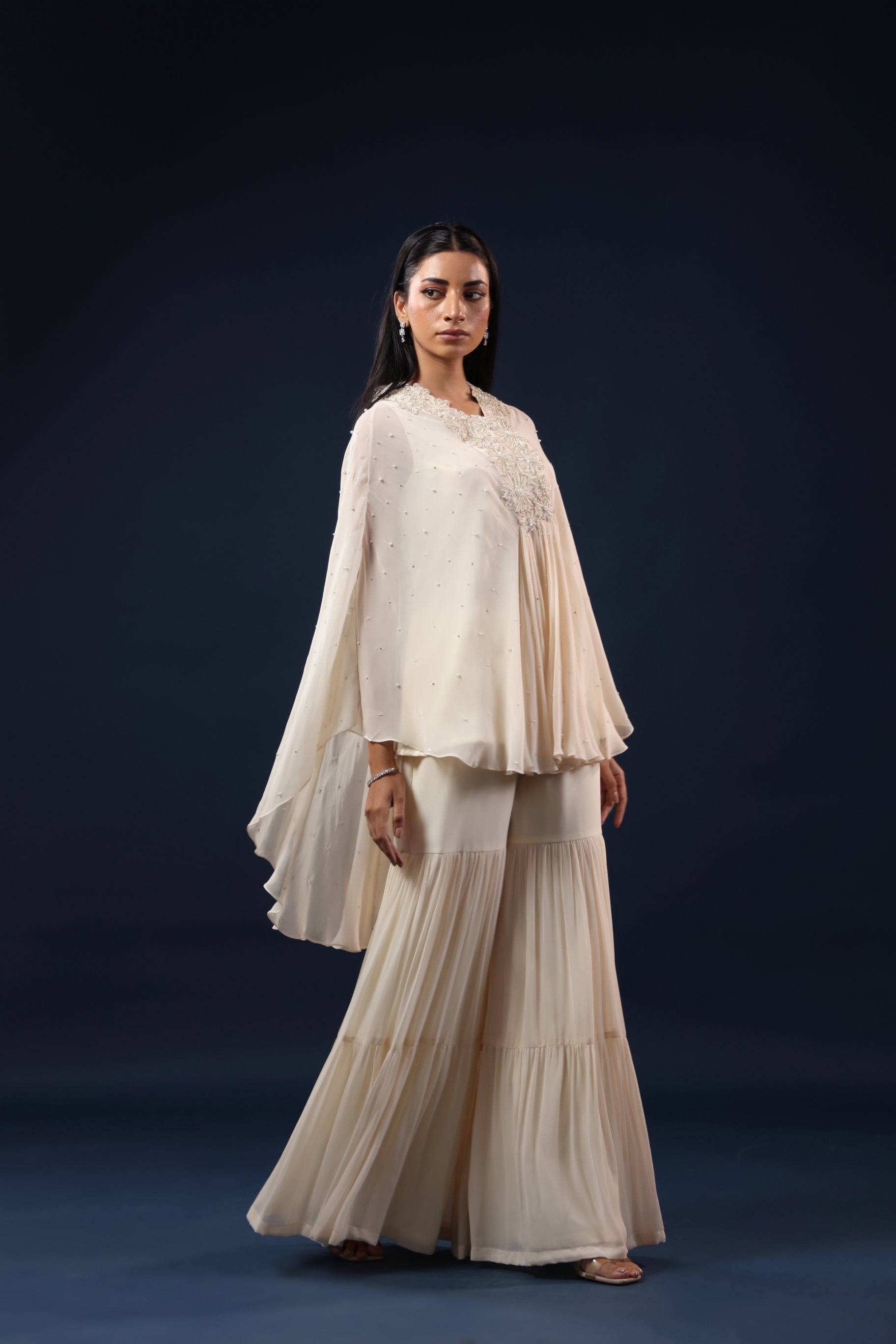 ELEGANT OFF WHITE CAPE TOP WITH FLARED PALAZZO PANTS.