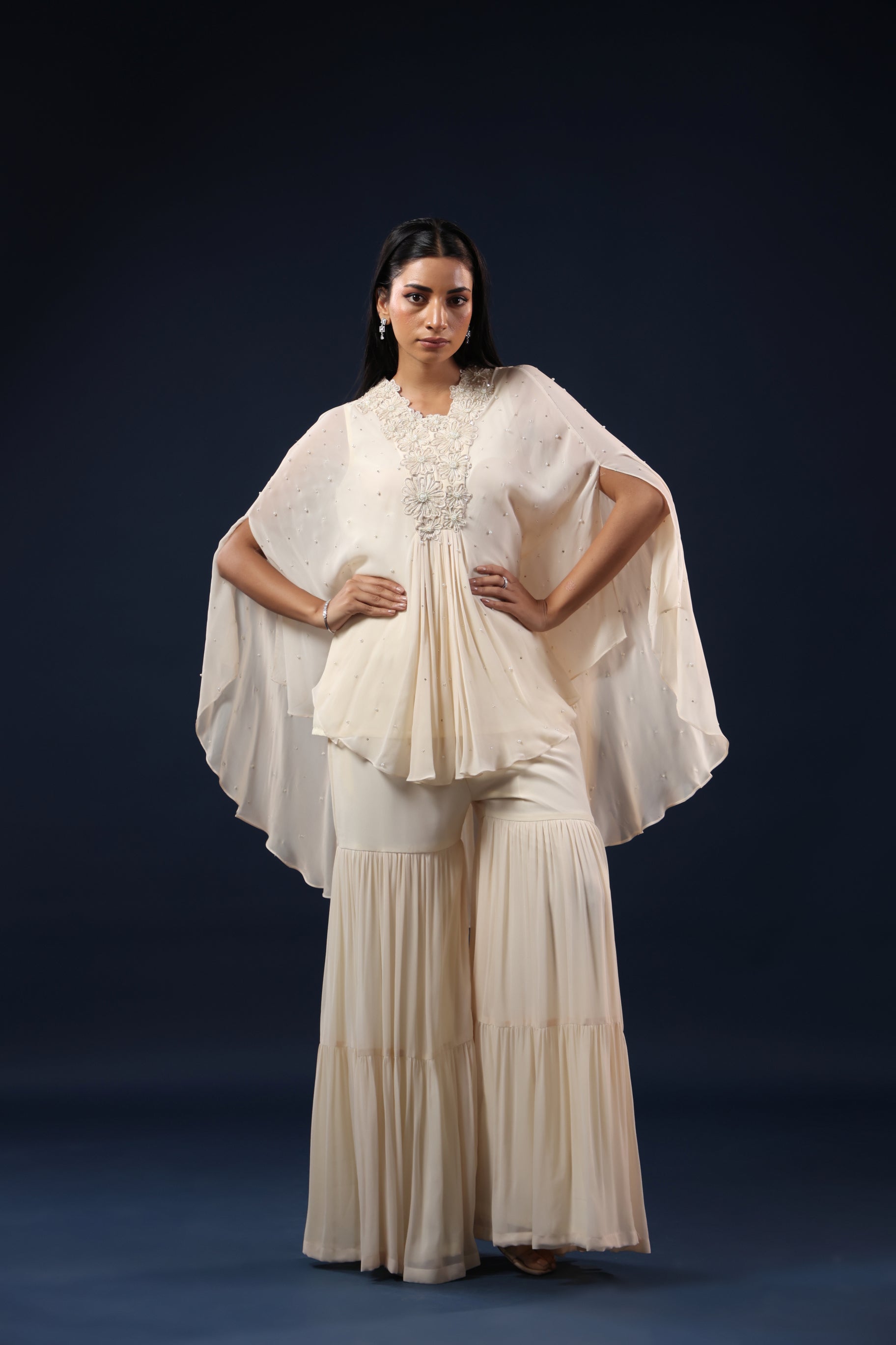 ELEGANT OFF WHITE CAPE TOP WITH FLARED PALAZZO PANTS.