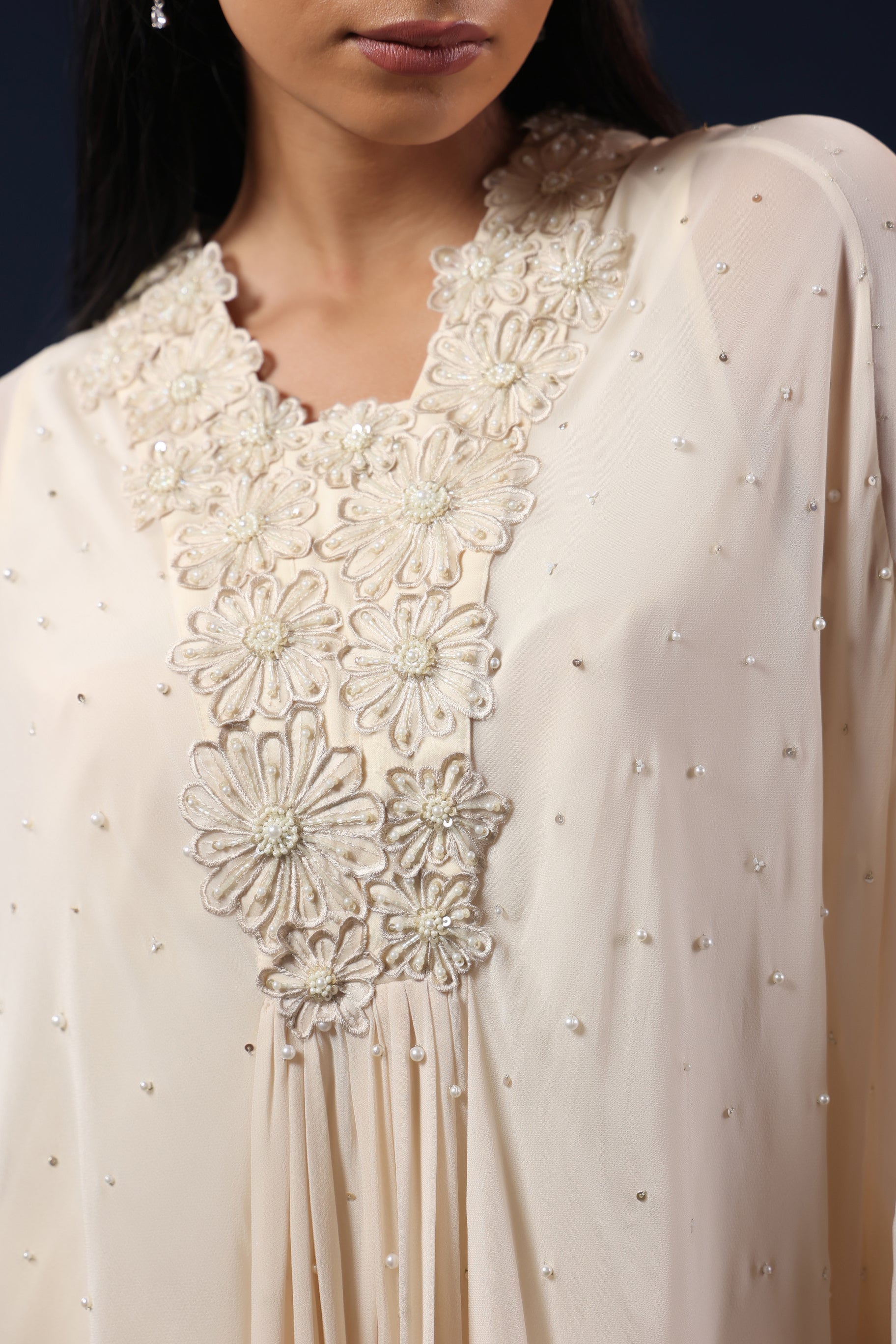 ELEGANT OFF WHITE CAPE TOP WITH FLARED PALAZZO PANTS.