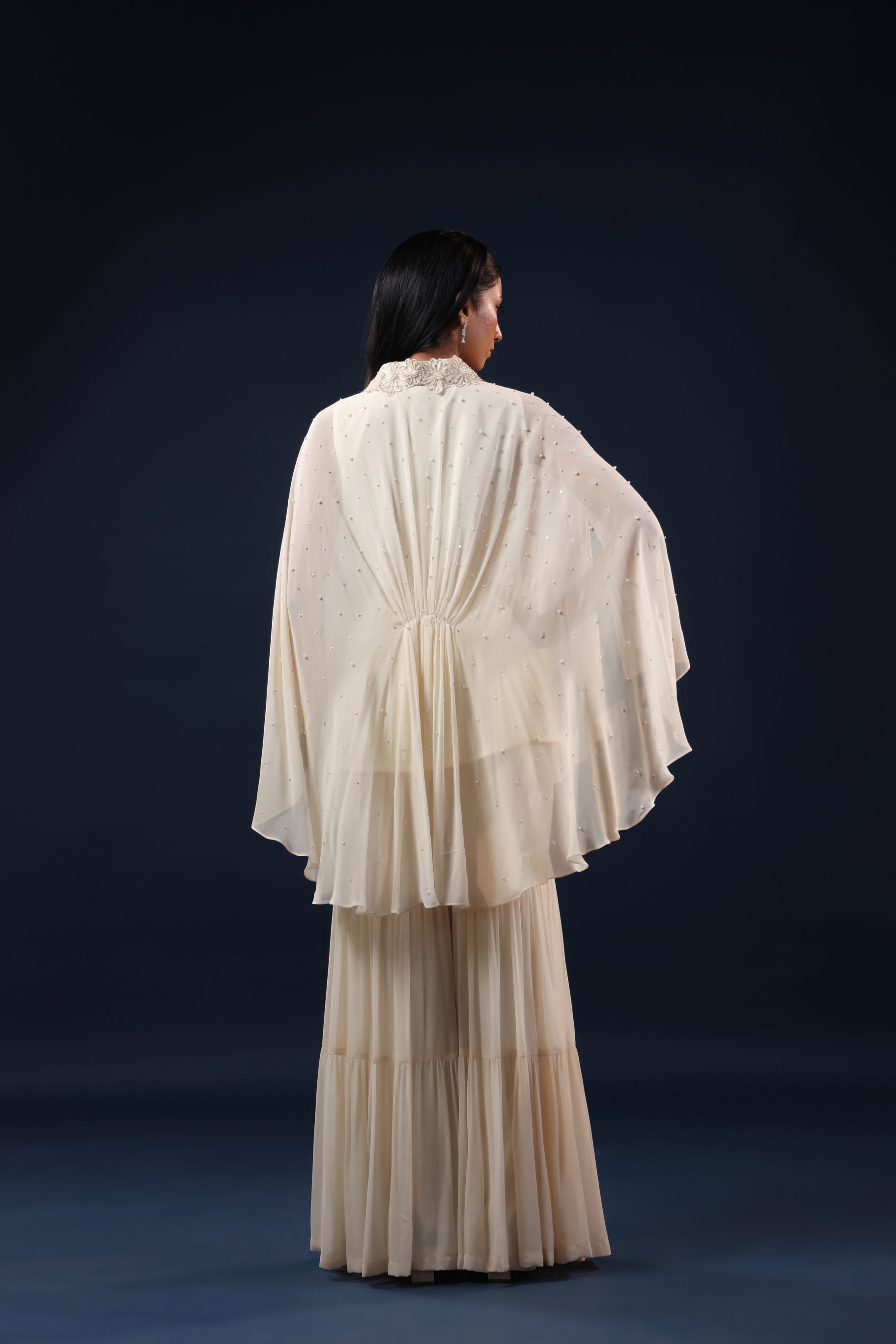 ELEGANT OFF WHITE CAPE TOP WITH FLARED PALAZZO PANTS.
