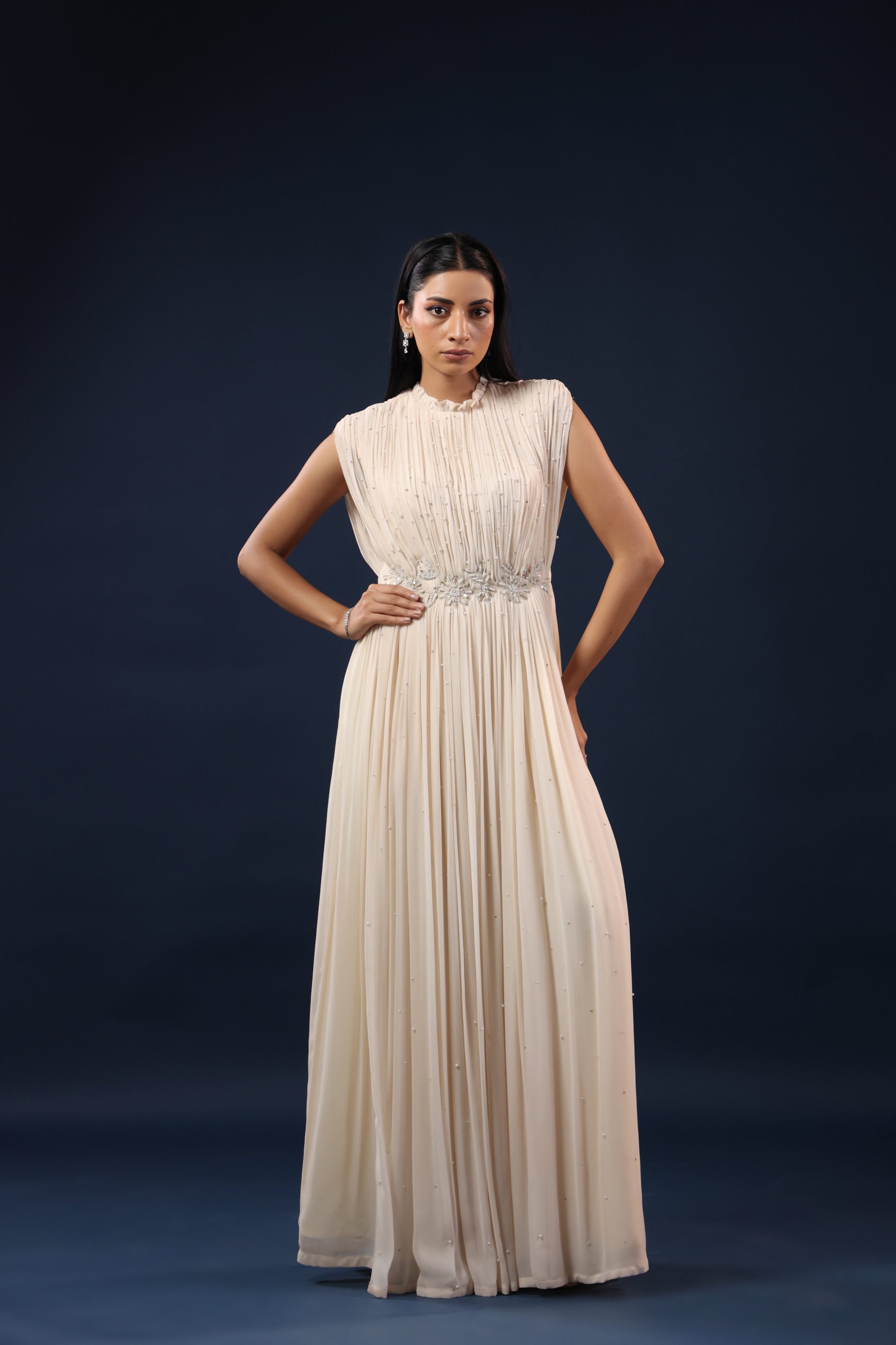 ELEGANT OFF WHITE PLEATED GOWN WITH EMBELLISHED WAIST.