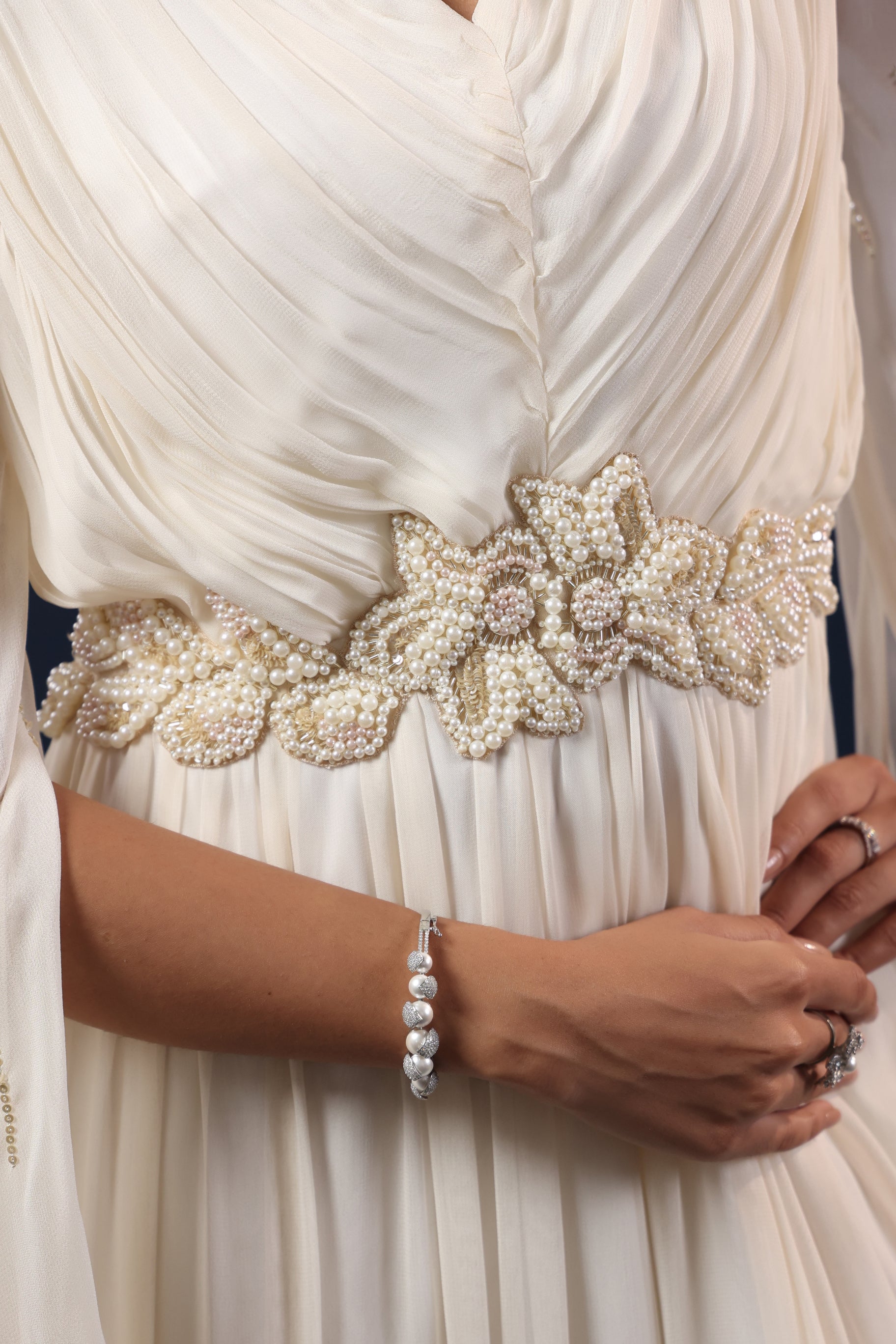 WHITE CAPE GOWN WITH PEARL WAIST WORK.