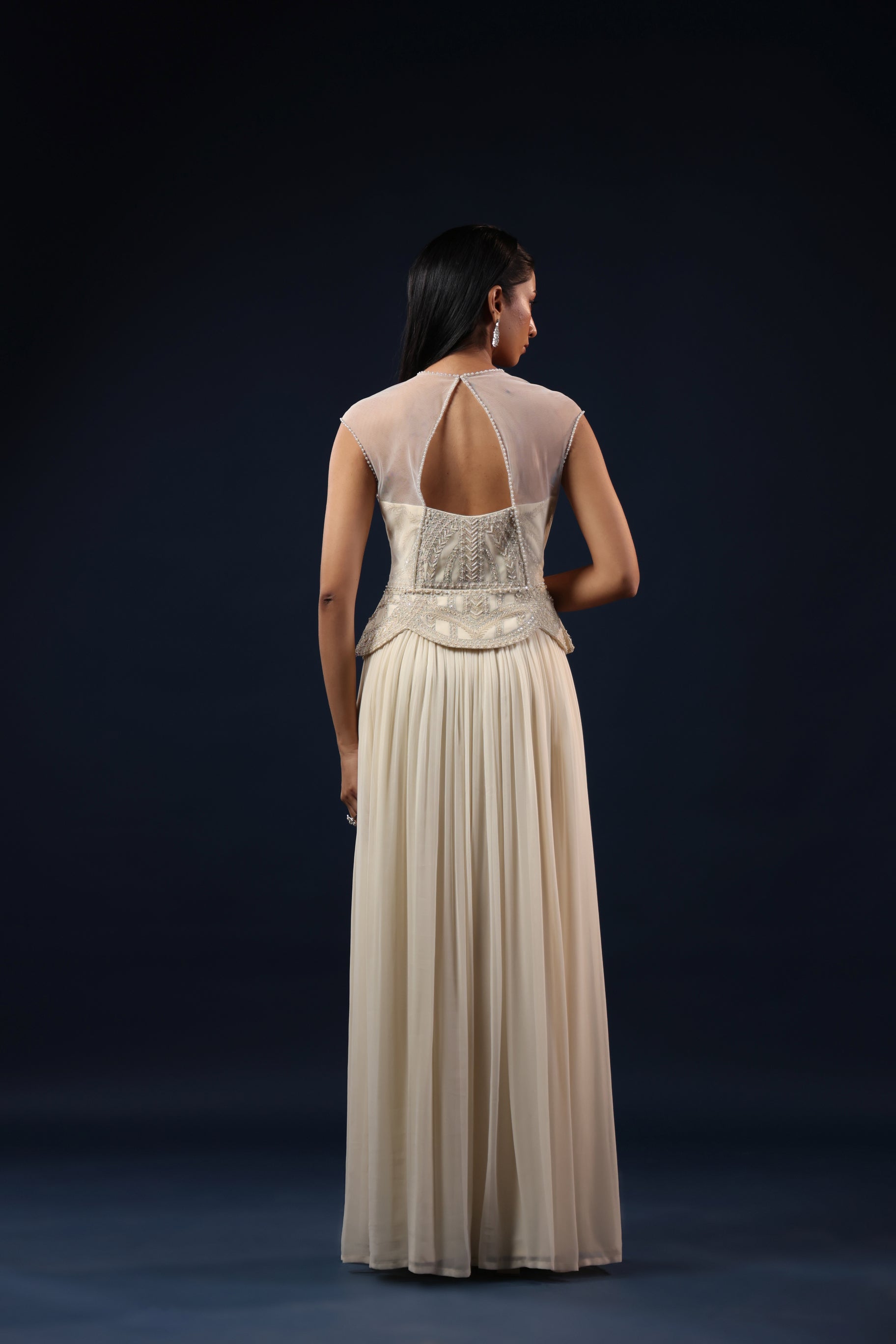 OFF WHITE PEARL EMBELLISHED PEPLUM GOWN.