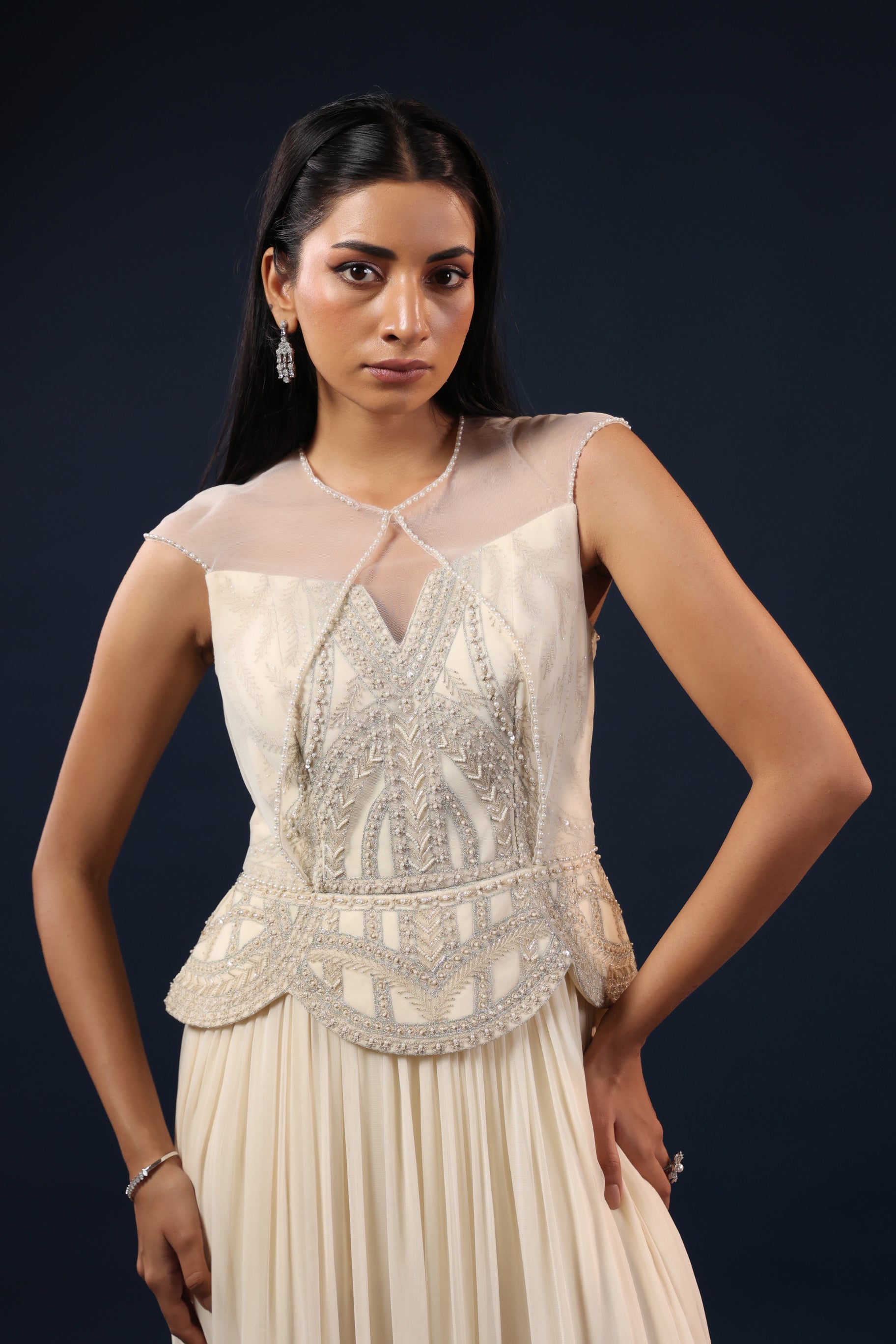 OFF WHITE PEARL EMBELLISHED PEPLUM GOWN.
