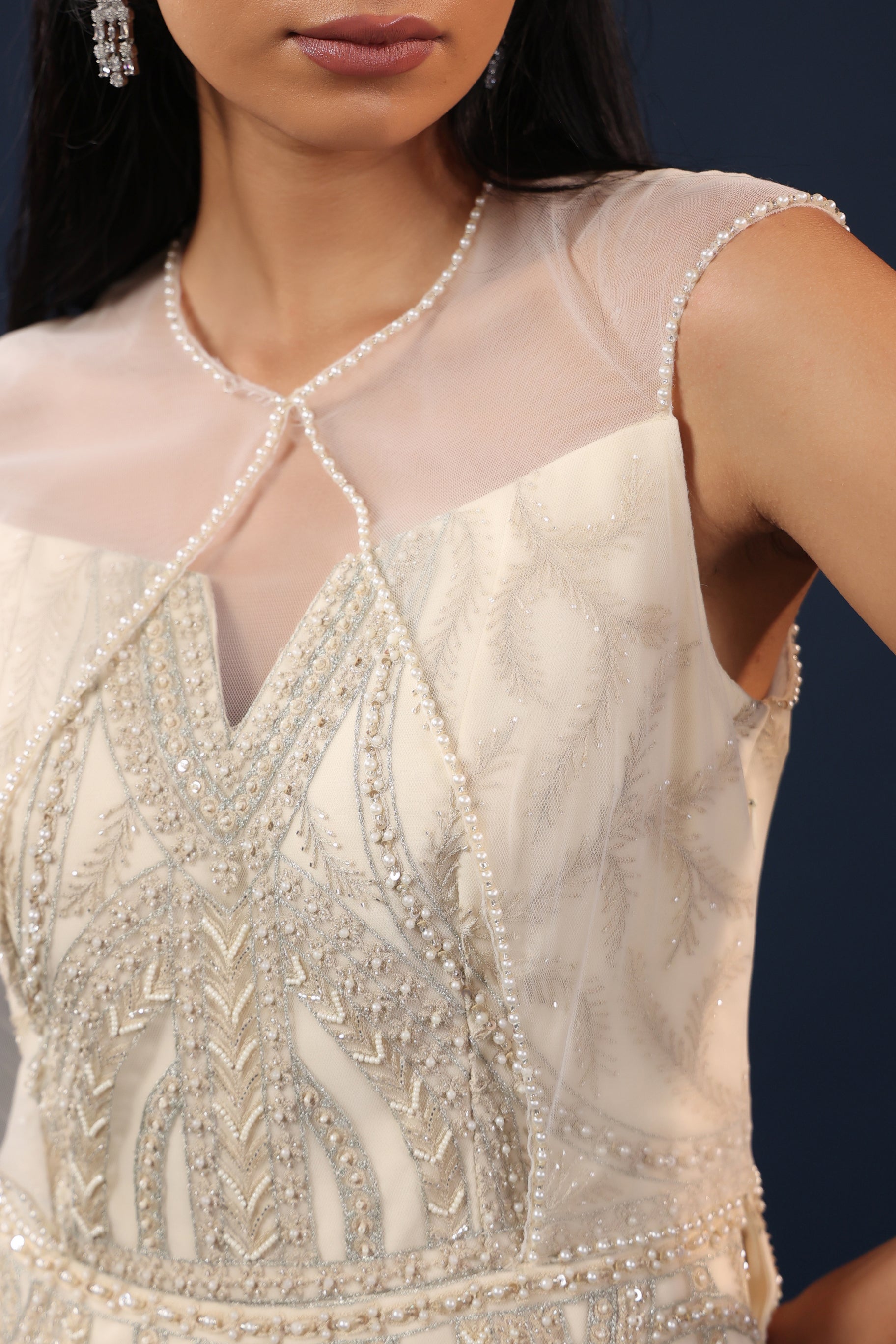 OFF WHITE PEARL EMBELLISHED PEPLUM GOWN.