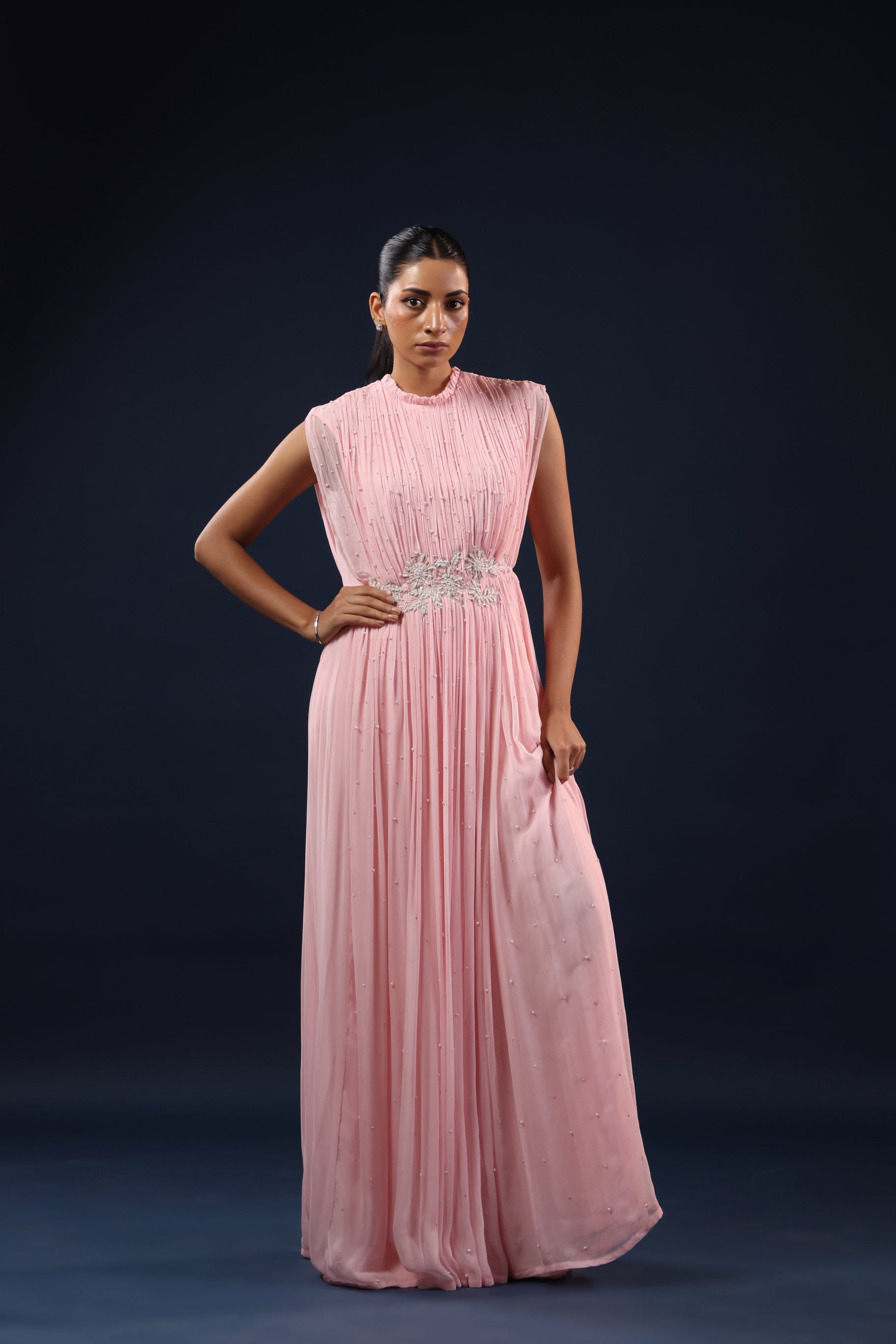 ELEGANT PINK PLEATED GOWN WITH EMBELLISHED WAIST.