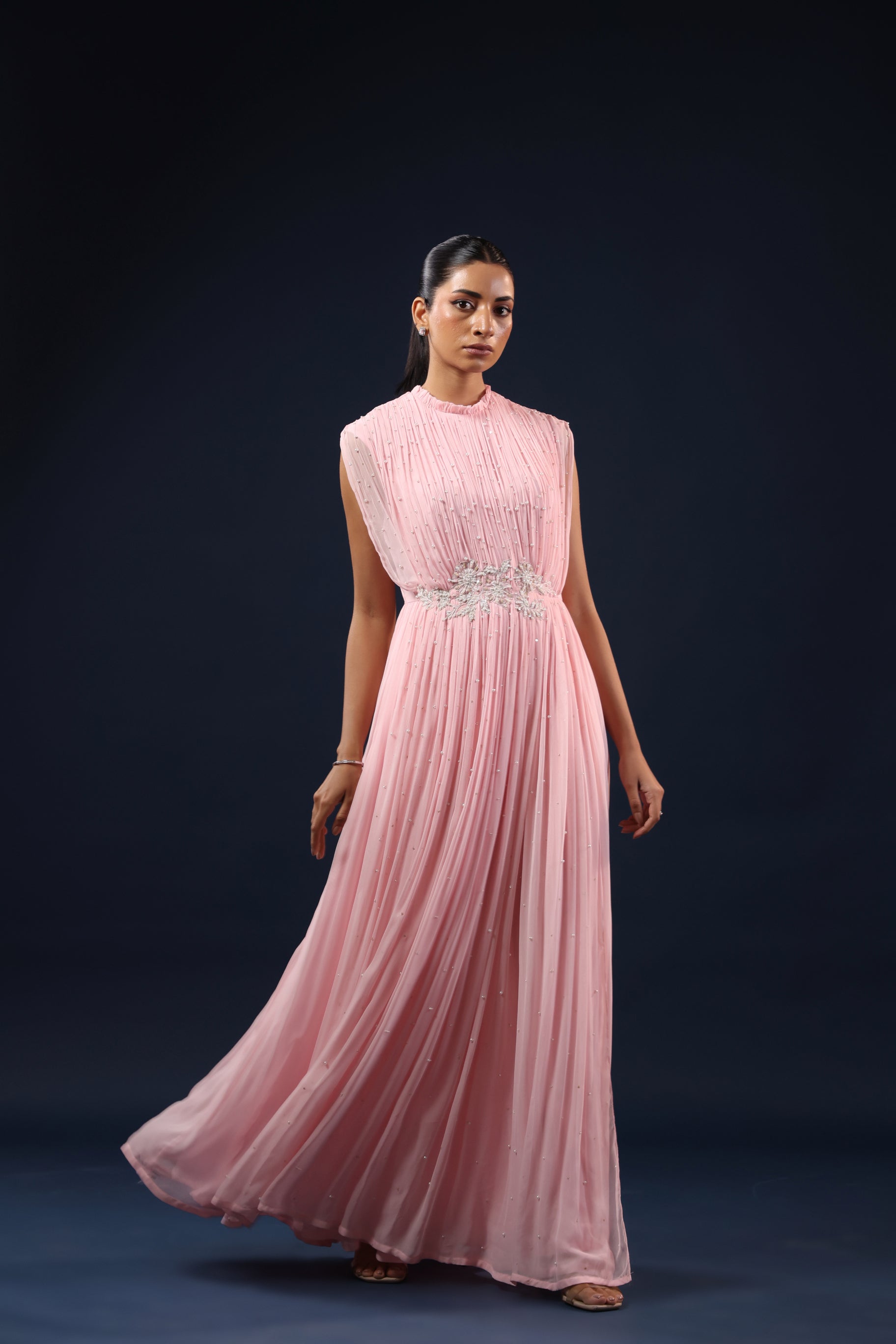 ELEGANT PINK PLEATED GOWN WITH EMBELLISHED WAIST.