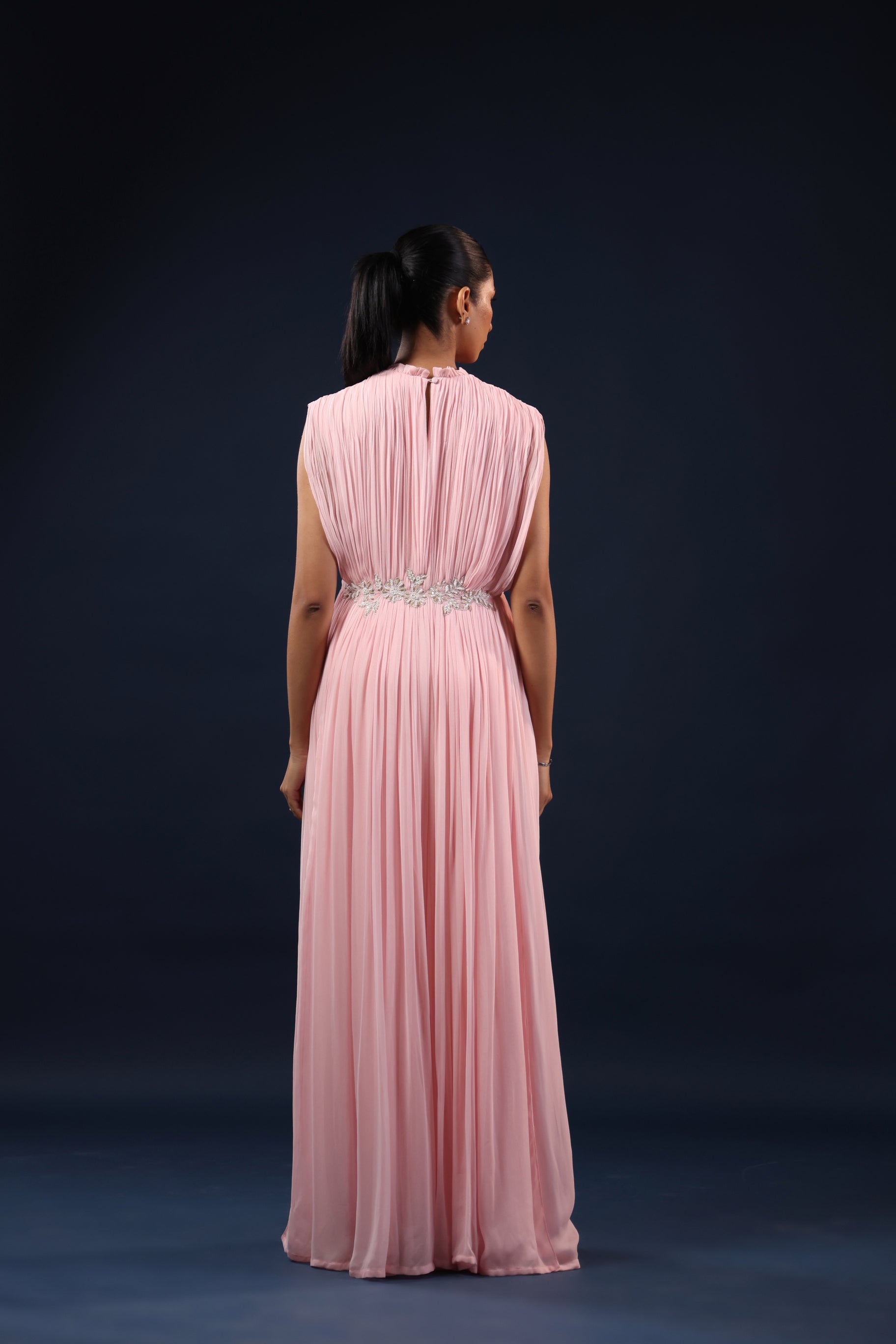 ELEGANT PINK PLEATED GOWN WITH EMBELLISHED WAIST.